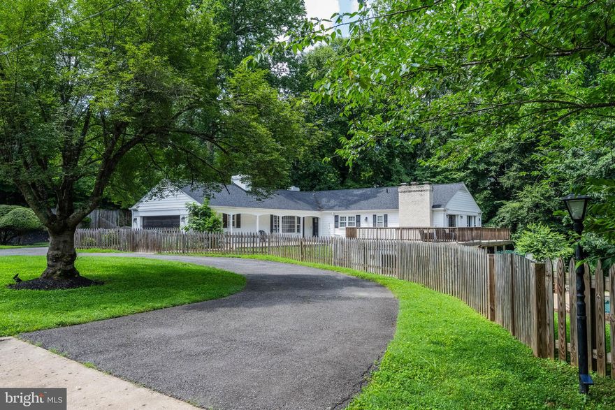 Price Reduced! Graciously nestled on a serene one-acre cul-de-sac lot in McLean, this charming ranch-style residence offers effortless one-level living in a picturesque wooded setting. A welcoming flagstone front porch leads to the foyer, where stone flooring, an oversized coat closet, and a conveniently located powder room set the tone for the home's thoughtful design.  The formal living room exudes warmth with rich hardwood floors, a classic wood-burning fireplace, elegant crown molding, and a sunlit bay window. The adjacent dining room offers built-in cabinetry, chair rail detailing, and sliding glass doors that open to a private patio, perfect for seamless indoor-outdoor entertaining.  The kitchen is both stylish and functional, appointed with cherry cabinetry, granite countertops, and a raised breakfast bar. It opens to a cozy family room (or optional breakfast area) highlighted by a striking floor-to-ceiling brick fireplace and a large picture window framing tranquil views.  A well-equipped mudroom with cabinetry and utility sink provides access to the side entry and attached two-car garage.  The generously sized primary suite is a true retreat, featuring four closets, a wood-burning fireplace, a picture window, and sliding glass doors leading to a private deck overlooking the lush wooded grounds and sparkling pool. The updated en-suite bath blends timeless and contemporary design with a crisp white vanity and sleek black-tiled tub/shower combination.  Two additional main-level bedrooms, each with hardwood flooring, share a renovated hall bath with a floating double vanity, granite countertop, and polished black tile tub/shower surround.  The walk-out lower level enhances the home’s livability, filled with natural light and a strong connection to the outdoors. It offers a spacious game area, a recreation room with brick fireplace and French doors to the patio and pool, two additional bedrooms, a full bath, and ample storage including both utility and cedar closets.  Outside, the grounds unfold into a private oasis with multiple patios and decks designed for both relaxation and entertaining. A sparkling pool invites summer enjoyment, while the expansive yard and concrete sports court provide endless opportunities for recreation. Surrounded by mature trees and serene wooded views, this exceptional property offers the perfect blend of comfort, privacy, and natural beauty. Langley High School, Cooper Middle School, Spring Hill Elementary School. Pets are considered on a case-by-case basis, with an additional pet deposit. Tenant to pay all utilities. Security Deposit is equal to first month’s rent. Repair deductible is $100 per incident. Available for immediate occupancy. Call for more information, application, or private showing.
