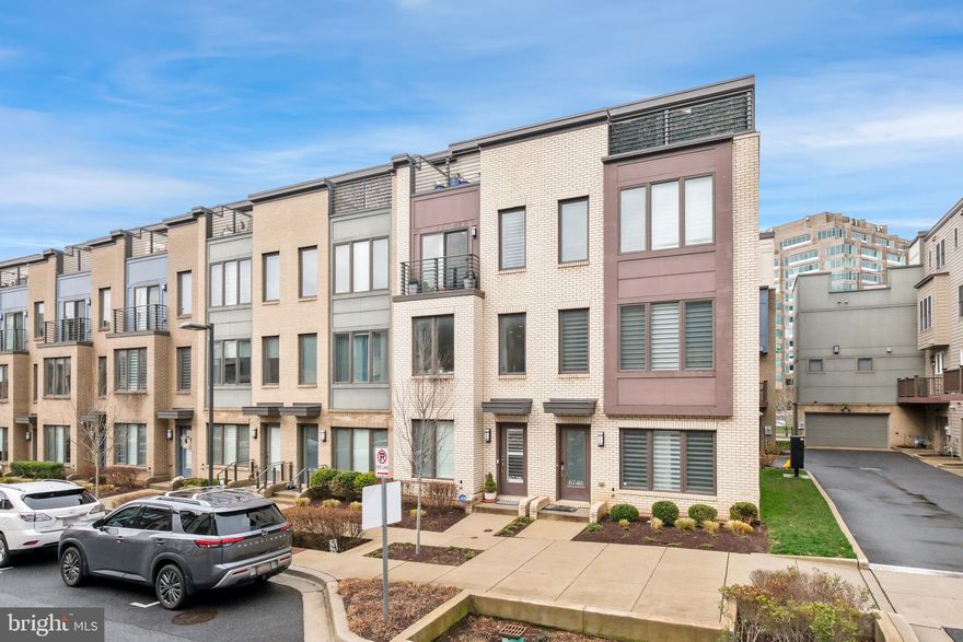 Welcome to 6738 Eames Way, a contemporary EYA townhouse built in 2019 and ideally situated in the vibrant Montgomery Row community. Spanning four above-ground levels, this beautifully designed residence offers 3 bedrooms, 3 full bathrooms, and a powder room. The top level features a spacious lounge that opens to a large rooftop deck with expansive views. Beautifully presented throughout, the home is distinguished by high ceilings, richly stained hardwood floors, recessed lighting, oversized windows that fill the interior with natural light, plantation shutters, electric drapes, multiple outdoor spaces, and private bathrooms for each bedroom. Recent improvements include a new hot water heater, new garbage disposal, and a new garage floor, all completed in 2026. The main level offers a bright, open-concept living and dining area that flows seamlessly into the gourmet kitchen and rear balcony. The chef’s kitchen boasts quartz countertops, Whirlpool stainless steel appliances, soft-close white cabinetry, a gas cooktop, wall oven, extra-deep farmhouse sink, and a pantry. A powder room completes this level. Upstairs, the bedroom level includes a spacious owner’s suite with a walk-in closet and an en-suite bath featuring a glass-enclosed shower, dual vanity, and contemporary tile finishes. Down the hall are a convenient laundry closet, multiple linen closets, and a second bedroom with a Juliette balcony and its own private bath. The top floor includes a third bedroom with an attached full bathroom, along with a bonus lounge area that offers wonderful flexible living space. Framed by a wall of sliding glass doors, the lounge opens to the expansive rooftop deck—perfect for entertaining or relaxing.The deck easily accommodates both patio furniture and a dining set, while offering peaceful sunset views. The entry level provides access to the attached two-car tandem garage, which features a new epoxy floor, built-in shelving, and a convenient storage lift. The HOA includes exterior maintenance, landscaping, snow removal, and community green space. Don’t miss this exceptional opportunity to own in a thoughtfully designed neighborhood close to restaurants, shopping, and parks. Commuters will appreciate the easy access to Metro and major commuter routes, while top-rated Montgomery County schools further enhance the home’s appeal.