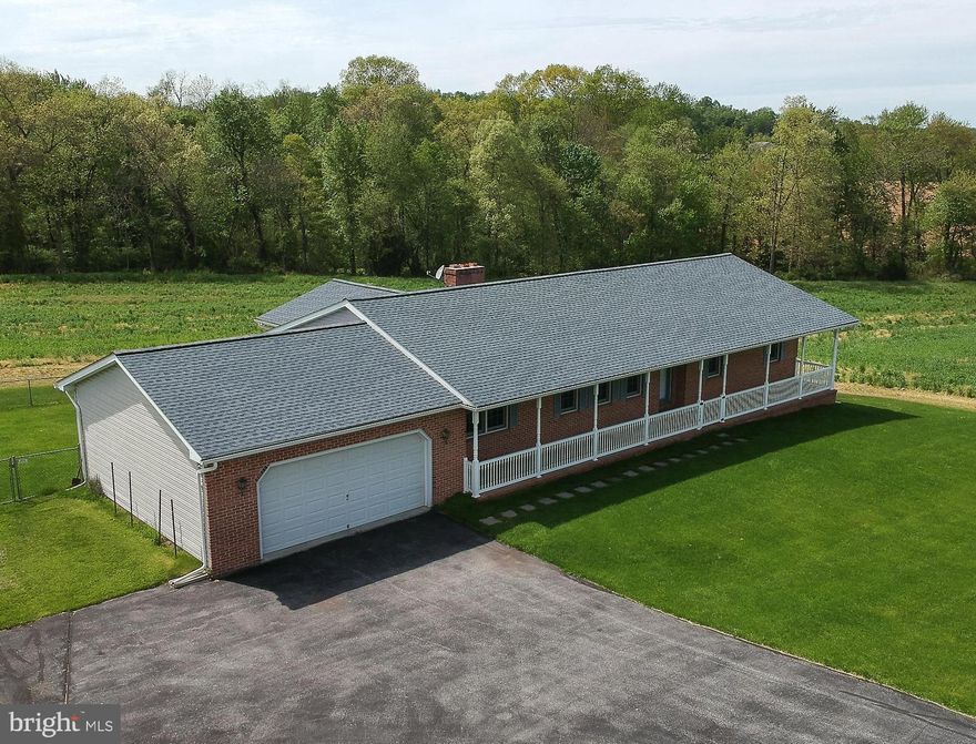 Spacious Rancher on open 6+acres.  Mostly clear but includes woods beyond the field. Ready to move right in to a Freshly painted home. There is a full walk out open basement for you to create room for all your ideas. Bath rough in.  Updated Propane gas furnace.  Buried Propane tank.  House Generator (gas run) included.The living room & dining room have pocket doors to provide privacy if needed.  The Brick Fireplace in the family room also has a gas line if you don't want to burn wood.  The eat in kitchen has room for you to install a giant island.  There are 2 pantries off the kitchen.  The first floor laundry also has a half bath.  Horses & cattle are allowed. crops currently reserved.