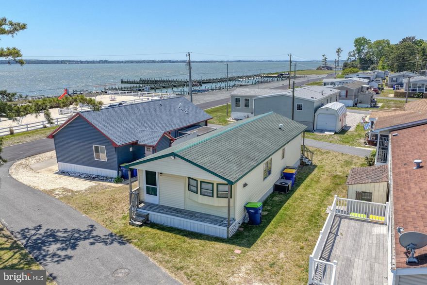Welcome to 27311 Dinghy Road in Millsboro, DE, located in the desirable White House Beach community. This unique property is located two lots off of the bay with beautiful views of the Indian River Bay and easy water access, perfect for enjoying coastal living. Community boat ramp and boat slip rentals are available, making it an ideal spot for boating enthusiasts. The home features 2 bedrooms and 1 bathroom, along with an additional living space that adds flexibility and comfort. A spacious deck wraps around one side of the home, creating the perfect place to relax and take in the bay-front scenery. White House Beach offers a prime location with access to the Indian River Bay and beyond, along with community amenities including private beach, tennis courts, basketball courts, a playground, three marinas, and golf cart friendly. Whether you’re looking for a weekend retreat or a year-round residence, this property offers a great opportunity to enjoy life by the water!