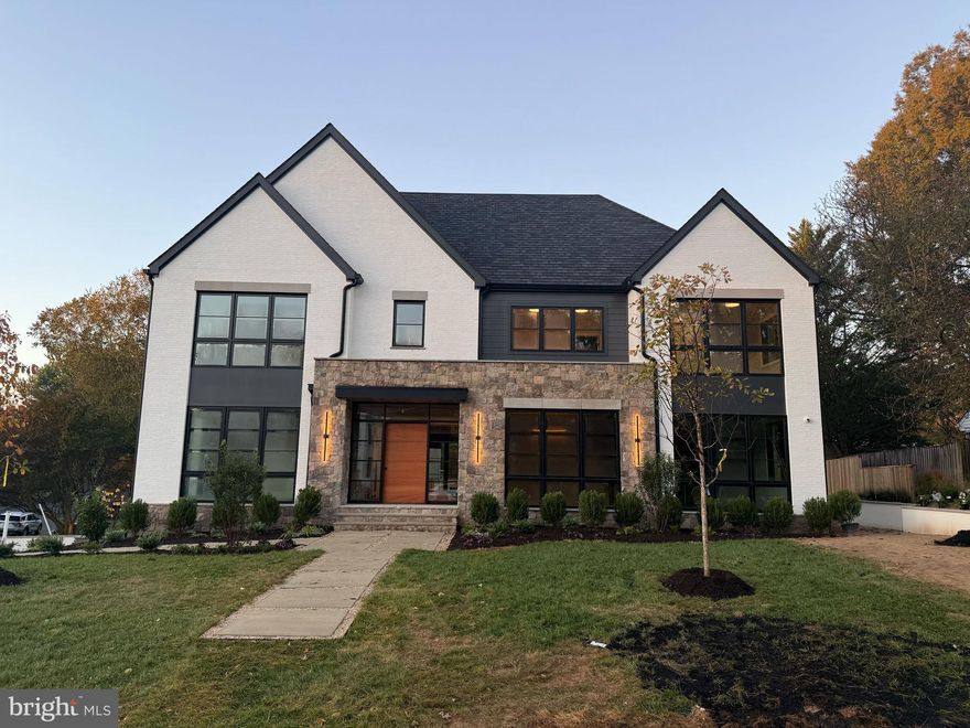 Premium craftsmanship and quiet luxury converge at 5909 Calla Drive, an extraordinary six-bedroom, six full and two half-bath custom home built by Morbill Custom Homes, a McLean-based builder with a legacy of excellence. Thoughtfully designed with architectural distinction, curated finishes, and seamless indoor-outdoor flow, this residence located in the McLean's most coveted close-in neighborhood, Chesterbrook Woods, blends sophistication with livable comfort across three beautifully finished levels. 

The main level centers on a dramatic two-story great room with a linear fireplace, custom white oak built-ins, and an entire wall of windows overlooking the professionally landscaped rear yard. The chef’s kitchen features a slab hood, oversized quartz waterfall island, white oak cabinetry, Perrin & Rowe fixtures, and a full suite of Miele appliances. A back kitchen/pantry with range, refrigerator, and dishwasher provides exceptional functionality. The layout includes formal and casual dining areas enhanced by stone columns and oak beams, a private study with built-ins, and a guest suite with an en-suite bath. A two-story butler’s bar with custom cabinetry and beverage center adds an elevated touch for entertaining. 

Upstairs, the owner’s suite serves as a luxurious retreat with a vaulted ceiling, fireplace, and a morning room featuring a wet bar with quartz waterfall counter. The spa-style bath offers floating vanities, heated floors, a soaking tub, and shower with multiple heads. Three additional en-suite bedrooms, a family lounge with fireplace, and a laundry room with quartz counters complete the level, providing both comfort and thoughtful design. 

The lower level is designed for recreation and wellness, featuring a full bar with leathered granite counters, illuminated shelving, and a slab fireplace. A glass-enclosed gym and cedar steam sauna create a private wellness experience, while a guest suite, powder room, and mudroom with custom built-ins provide convenience and flexibility. The three-car garage with epoxy flooring underscores the home’s attention to detail.  

Throughout the home, six fireplaces, wide-plank European oak floors, and a floating mono-beam staircase highlight the craftsmanship. Integrated Sonos audio, smart home security with cameras, a three-stop elevator, four-zone Carrier HVAC, two Rinnai tankless water heaters, a whole-house humidifier, and a 26 KW Briggs generator - ensure comfort and efficiency. 

The home’s transitional façade combines stone, brick, and Hardie siding for timeless appeal, while a solid contemporary mahogany front door opens to a foyer with stone columns and cedar ceiling. Outdoor living spaces include a screened porch with a stone fireplace, patio and walkways with cast concrete details, and a fully fenced rear yard with professional landscaping.

Perfectly situated only 1 light to DC and near parks, top-rated schools, and major commuter routes, 5909 Calla Drive embodies the best of McLean living—where architectural excellence, refined finishes, and modern convenience create a lifestyle of everyday luxury.