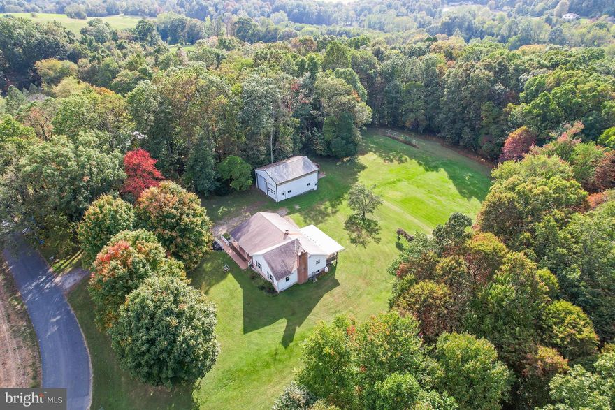 Living large on the Mason Dixon line.  You can not beat the setting of this farmette on 8 acres of property.  Three bedroom/2 bathroom home is just what you have been looking for to escape the hustle and bustle  of city living. Property is the perfect mix of a large level backyard which opens up to acres of woods perfect for  hunting, hiking or just enjoying the beauty of nature  in every season.   500+sqft.  pole building with concrete floor, electric service, and three bay doors to be used   for every hobby involving wheels or the best party barn ever is ready and waiting.  The home is in need of cosmetic updates but has been very well maintained over the years by the  original owner.  I promise after visiting this property; you will not want to leave.
