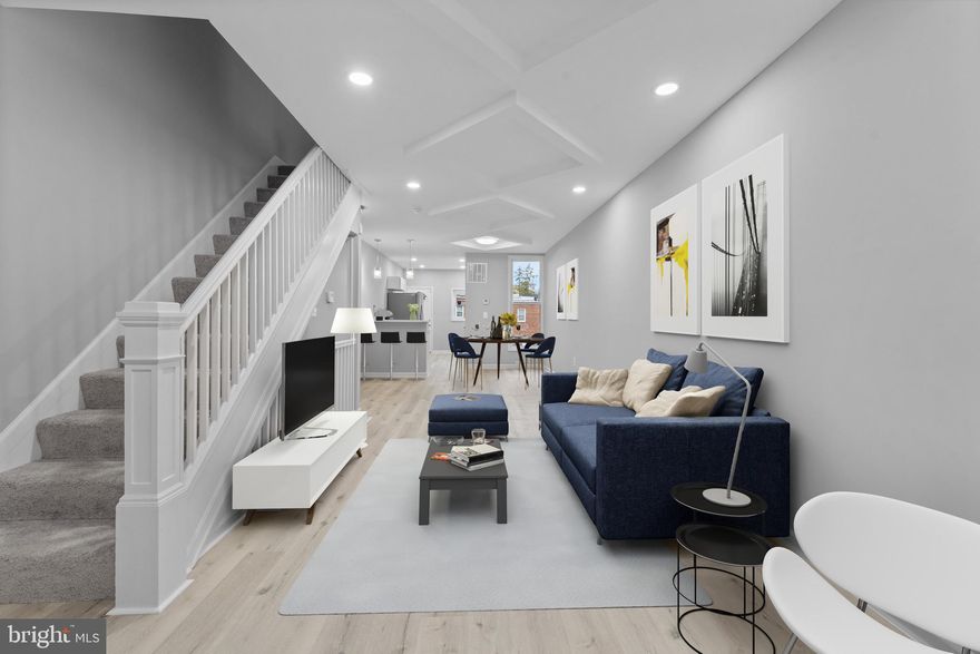 Price Reduction! This property could qualify for Maryland Mortgage Program, Buy Back the Block, Live Near Your Work Incentive Program, Baltimore City Employee Homeownership Program incentive, First-Time Homebuyers Incentive Program (FTHIP).  This spacious townhome in Edmondson Village has been fully renovated.  The moment you walk in through the covered porch, you’ll love the open layout featuring a spacious living room and dining area, adorned with modern ceiling accents.  The updated kitchen boasts sleek white shaker cabinets, quartz countertops, and brand-new stainless steel appliances.  Upstairs, you’ll find 3 comfortable bedrooms and an updated full bathroom.  The fully finished basement includes a family room with ample space for entertaining and a second full bathroom.  Enjoy the outdoors with a large private deck.  Parking is no problem.  The CAR PAD in the rear will accommodate your vehicle, with extra parking in the front.  This property is conveniently located near shopping, dining, schools, and major commuter routes. . Don't miss the opportunity to make this townhome your own! Schedule your private showing today.  Some photos have been virtually staged to help visualize how the rooms can be furnished. Actual property may appear different in person.