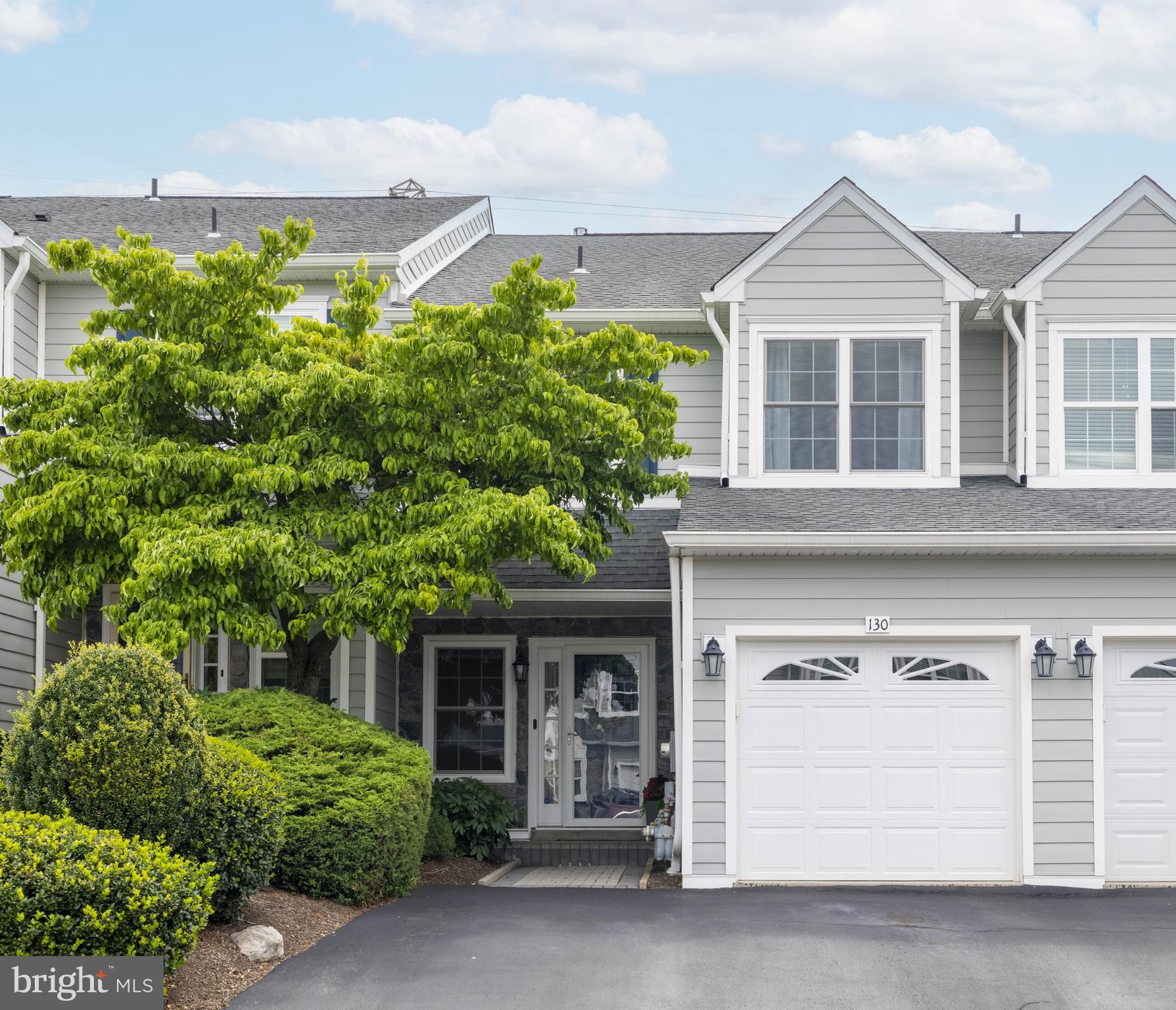 This beautifully updated townhome truly checks every box—modern style, thoughtful upgrades, and an unbeatable location. Nestled on a quiet street in the highly desirable Oakwood at Plymouth community and within the award-winning Colonial School District, this home offers over 2,500 square feet of impressive living space.
As you enter the neighborhood, the stunning curb appeal is immediately noticeable thanks to a full exterior renovation completed in 2021, which included new composite siding, double-hung windows, sliding glass doors, updated exterior lighting, and freshly painted garage doors. This particular interior unit also features a unique upgraded paver entryway and a charming covered front porch, adding both style and functionality.
Inside, the welcoming foyer offers a double coat closet and gleaming hardwood floors, refinished in 2020, which lead into an expansive great room. With soaring nine-foot ceilings and a double-sided gas fireplace as the focal point, the open layout provides a perfect blend of comfort and sophistication.
The spacious eat-in kitchen is a dream for entertaining, featuring a large island, quartz countertops, a classic subway tile backsplash, timeless white cabinetry, and beautiful hardwood floors. A walk-in pantry adds convenience, while stainless steel appliances, including a brand new (2025) Frigidaire Professional refrigerator, enhance the overall functionality. The adjoining dining area exudes elegance with grasscloth wallpaper and a statement modern chandelier, all framed by large sliding glass doors that lead to a spacious outdoor deck—perfect for grilling and hosting.
Also on the main level is a convenient powder room, beautifully updated in 2022 with a new sink and toilet.
Upstairs, the primary bedroom suite is your private oasis. It features cathedral ceilings, a ceiling fan, ample natural light, a large walk-in closet, a secondary closet, and an en-suite bathroom with a double vanity, soaking tub, and stall shower. Two additional generously sized bedrooms with large closets and a full hallway bath with a shower-tub combo complete this level. A laundry room is conveniently located in the hallway and includes a brand new (2025) LG washer and gas dryer.
The finished third floor offers over 200 square feet of additional living space and is currently used as a fourth bedroom. This area includes three large closets for added storage and its own ductless HVAC unit for efficient heating and cooling, making it a great option for guests, a home office, or a hobby room.
The professionally finished basement, completed in 2020, adds even more flexibility. It features luxury vinyl plank flooring, recessed lighting, and thoughtfully designed spaces for a family room, home office, and exercise area. A built-in refrigerator makes it ideal for entertaining, while multiple storage closets and a dedicated utility room provide practical everyday convenience.
This home also boasts a number of major system upgrades, including a brand new hot water heater (2024), updated water softener (2023), sump pump, French drain, and sprinkler system. Additional features include hard-wired smoke and carbon monoxide detectors in every room, an ADT security system, and a full Nest system with video doorbell, thermostat, and integrated safety devices.
Adding to the ease of ownership, the HOA covers lawn care, snow removal, trash, and exterior maintenance, so you can simply move in and enjoy everything this incredible home has to offer.
With modern updates, generous living space, and a prime location near shopping, restaurants, parks, and major routes, this home is ready for you. Don’t miss your chance—schedule your private showing today!