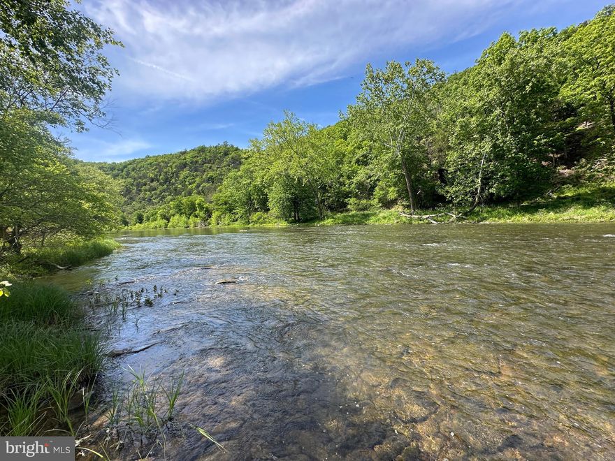 RIVER FRONT....BARGAIN HUNT.....1.19 ACRES WITH 145 FT OF FRONTAGE ON WV'S CLEANEST RIVER "THE CACAPON" FLAT FRONT, COVERED IN TOWERING POPLAR TREES, PLENTY OF LEVEL SPACE FOR YOUR CAMPER OR TO BUILD AN ELEVATED CABIN. THE ENTIRE LOT IS IN THE FLOOD ZONE BUT IT MAY BE POSSIBLE TO BUILD ON PILINGS OR STILTS 10-12 FT OR SO UP TO BE OUT OF THE FLOOD ZONE. YOU'LL PASS BY ELEVATED CABINS ON THE WAY THERE TO GIVE YOU AN IDEA.  AT A MINIMUM, IT WOULD SERVE AS A GREAT CAMP LOT. WHY SO CHEAP? YOU HAVE TO CROSS OVER A BACKWATER TO GET TO THE RIVER, DURING THE SUMMER CAMP SEASON, THIS BACK CHANNEL IS MOSTLY DRY. WHEN YOU GET TO THE RIVER, IT'S FANTASTIC.....ALL 145 FT OF FRONTAGE IS ON A HUGE FLAT ROCK BAR. THE CATCH HERE IS THAT YOU'RE NOT GONNA GET YOUR CAMPER RIGHT TO THE RIVERS EDGE, ABOUT 200 FT BACK IS AS CLOSE AS YOU'LL GET BUT THAT PUTS YOU CLOSER TO THE ELECTRIC. THIS PROPERTY IS A KEEPER, IT'S BEEN IN THE SAME FAMILY FOR 58 YEARS! IT'S TIME TO START YOUR OWN FAMILY LEGACY OF SUMMER FUN.....CAMP, FISH, SWIM, CANOE, KAYAK, TUBE OR JUST SET YOU CAMP CHAIR IN THE RIVER AND ENJOY YOUR FAVORITE BEVERAGE ON A HOT SUMMER DAY! HANDS DOWN THE BEST DEAL YOU'RE GONNA FIND ON THE RIVER.....FOR THOSE WITH SOME VISION, THIS COULD BE A REAL GEM. DON'T LET THIS BE THE BIG FISH THAT GOT AWAY, SET THE HOOK ON THIS DEAL TODAY!