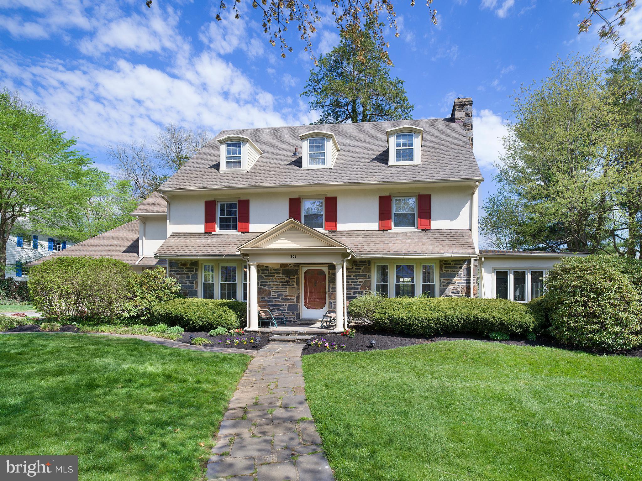 Welcome to this newly renovated, beautiful, 5/6 bedroom Center Hall colonial, located on one of the prettiest blocks Merion, that is a move-in-ready WOW! A massive six month renovation in 2022, updating every inch of space, means you don’t have to. The project was entrusted to an award-winning interior designer, who took this generously proportioned, light flooded house to the next level. The finishes and custom millwork reflect modern design trends, while thoughtful design ensures convenient family living. Picture the graciousness, workmanship and elegance of a 100 year old home with all of today’s luxuries. Highlights include a fabulous chef’s kitchen, new flooring, lighting, carpeting, painting and window treatments, a converted gas fireplace connecting living and family rooms, and a primary suite with private dressing room and two brand new his-and-her bathrooms.
Step into the inviting foyer and discover a home where every room boasts windows with two exposures, ensuring light throughout the day. To the right is lovely, airy living room whose centerpiece is a beautiful vintage fireplace mantle, newly converted to gas, with glass French doors leading to the family room with custom cabinetry. To the left of the foyer is an attractive dining room that can comfortably seat 14 guests. Flowing from the dining room is the gourmet kitchen, showcasing light custom cabinetry, granite countertops, subway tiled backsplash, stainless steel Thermador appliances, 2 ovens, a warming drawer, 2 sinks, 2 Asko dishwashers, and a banquette breakfast area. The highlight is one wall of original stone, a stunning backdrop to the rest of the kitchen. Conveniently located off the kitchen is a 2-car attached garage, a door leading to the yard, a back door leading to a BBQ, and a rear staircase that leads to the second floor. A powder room serves the first floor.
The main staircase leads to the second floor, where you'll discover two large bedrooms sharing a renovated Jack and Jill bathroom, along with a generously sized room currently used as a home office. The primary bedroom suite boasts dual, gut-renovated full baths, a dressing room with built ins, as well as a new washer and dryer. Continuing to the third floor, find two, giant, additional bedrooms sharing an updated hall bath, with one bedroom featuring an attached sitting room. The finished lower level offers potential as a playroom and exercise room. Situated on a corner lot in a prime location, this property presents a wonderful opportunity to live in the home of your dreams.