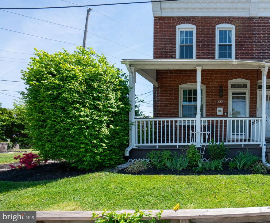 Welcome home to this end unit brick rowhome, built in 1906, in the heart of North Wales Borough. This home was completely renovated in 2013 with replacement windows, both the Kitchen and Bathroom were renovated, new Heater, and all flooring, with additional improvements up until current day. The property has an additional parcel side yard which includes 2 off-street parking spots with new gravel. The home has 1,150 sq feet of living space, including 2 Bedrooms, 1 Bathroom, and 2 spacious covered porches. Enter the charming side porch into the Kitchen. The Kitchen features ample cabinet storage and preparation space, with stainless steel appliances, laminate flooring, and a sweet picture window with a view of the backyard. Step into the Dining Room with hardwood laminate flooring and the door to the Basement. Follow the hardwood into the Living Room with an abundance of natural light with both side and front windows, and a stained-glass transom window above the front door. Step out front on the covered front porch with composite deck planks (2022). Up the stairs to the second floor with all new carpeting (2023), are the 2 Bedrooms and full Bathroom. The primary Bedroom has a walk-in closet and plenty of natural daylight. There is a broad hallway with a deep linen closet and access to the full Bathroom with tile flooring, and a tub/shower with tile surround. The charming back Bedroom has painted exposed brick and a storage closet. The Basement has a laundry area, storage, heater (2013), and the water heater (2020). The foundation was improved by Value Dry water proofing (2015) and a new sump pump (2024). The outside yard and porch create a serene atmosphere and are great for entertaining with room for a grill and possible fire pit. This home has been lovingly cared for and is in a great location with walking access to the Lansdale/Doylestown train station, and local parks including the Green Ribbon Trail, Parkside Place Park, Dodsworth Preserve and Weingartner Park, along with 2 breweries and local restaurants.