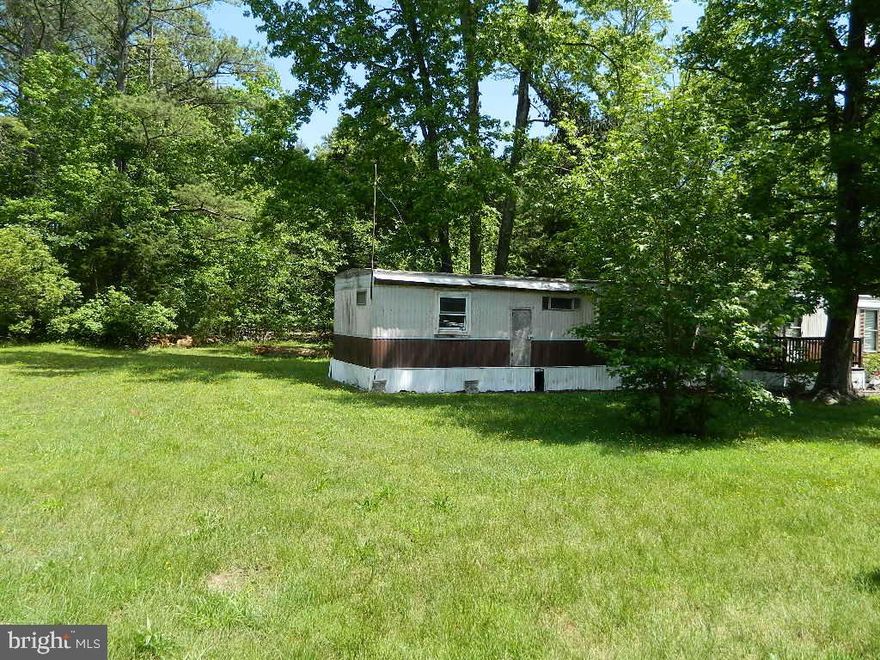 Tranquil Seventh District location.  Much of the work is already done for a new home. There is a driveway, cleared lot with established lawn. Electric has been run to the site. There is a septic system that was used when the trailer was occupied but there is no well. The trailer is old and not livable.