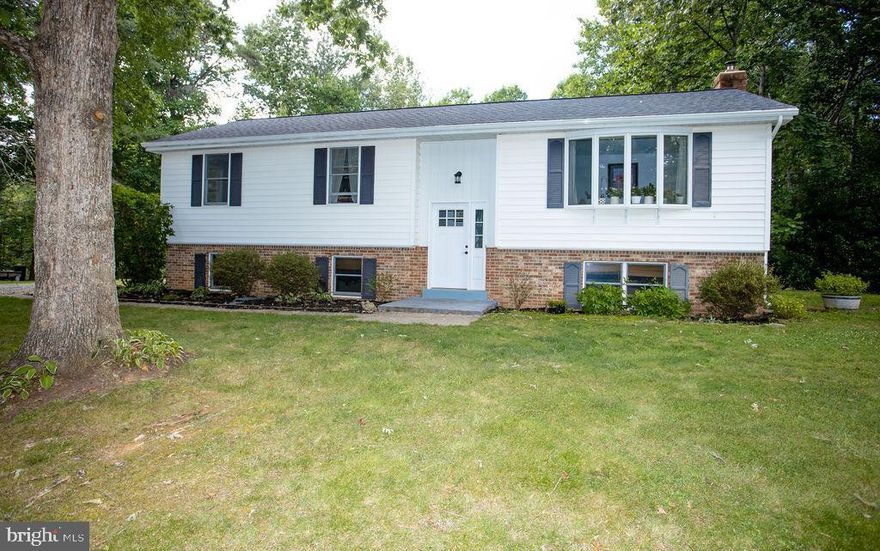 This charming, meticulously maintained,  and upgraded home has everything you are looking for! Nestled on almost 2 acres of green grass and trees- this property welcomes you to the peace and tranquility that is country living! The home features 3 bedrooms and 3 baths with a large 4th bedroom in the basement! The gorgeous kitchen was renovated in 2017 with beautiful exotic granite countertops, a gas range, new flooring, and new stainless steel appliances! The fully finished basement features a large living room/playroom area with a beautiful brick fireplace and wood burning stove. The basement features the large 4th bedroom with plenty of closet storage! The basement also features a full bathroom and laundry room/mudroom with plenty of cabinets and shelving for storage! Walk out of the basement into the HUGE backyard. The large deck was just refinished and stained this year- the ideal spot for grilling and relaxing while enjoying the outdoors. A beautifully landscaped fish pond is nestled in the side yard- a perfect place to kick back and relax! New roof was installed in 2019. New front door was installed in 2021. Several trails, parks, and wildlife recreational areas are just a short drive away for you to enjoy as well! Come check out this beautiful home today!