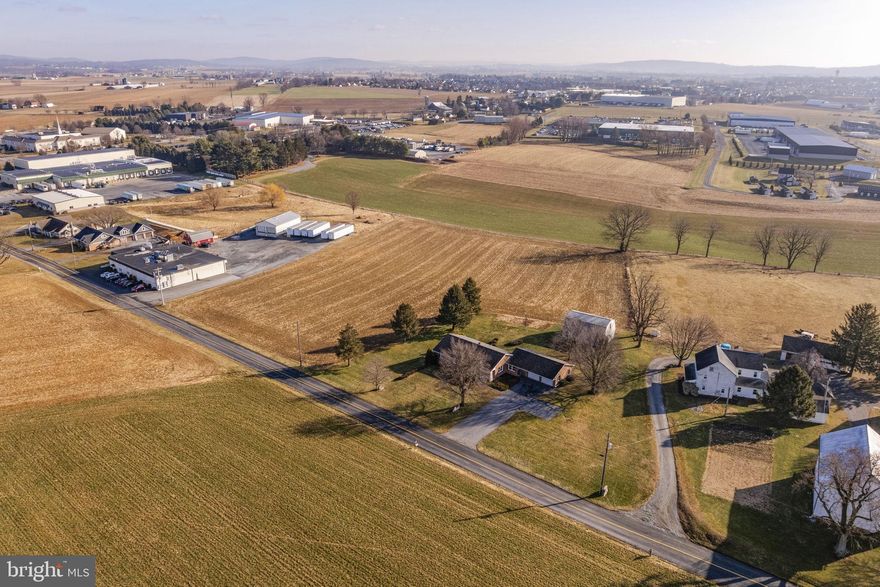 AUCTION DATE - TUESDAY, MARCH 17, 2026, AT 4 PM. LISTED PRICE IS AN OPENING BID ONLY AND IS NOT INDICATIVE OF THE FINAL SALE PRICE. REAL ESTATE: 5.2 ACRES - ZONED LIGHT INDUSTRIAL. Custom one-owner brick rancher w/2009 SF finished area, eat-in kitchen w/custom oak raised panel cabinets, appliances & patio door to rear patio, living room w/bow window, 3 bedrooms, 2 full baths, 1st floor laundry/mudroom, full basement w/partially finished rec. room w/woodstove, utility & storage rooms, oil baseboard heat, central AC, insulated windows, covered front porch, large attached 2-car garage w/overhead storage. Outbuilding: 2-story barn 36x26 w/2nd floor storage all on level 5.2 ACRE country lot w/tillable land, surrounded by farmland, mature shade, double-width macadam driveway, on-site well & septic, low traffic road. Zoned Light Industrial. NOTE: Ideally located custom one-owner solid brick rancher w/open floor plan, large garage & barn. Convenient location, minutes to Clay, Ephrata & Lititz w/easy access to Rts. 322, 272 & 501. Terms 10% down, balance 60 days or before. Personal inspection by appointment or open house Sat., February 28, March 7 & 14 from 1 to 4 PM.