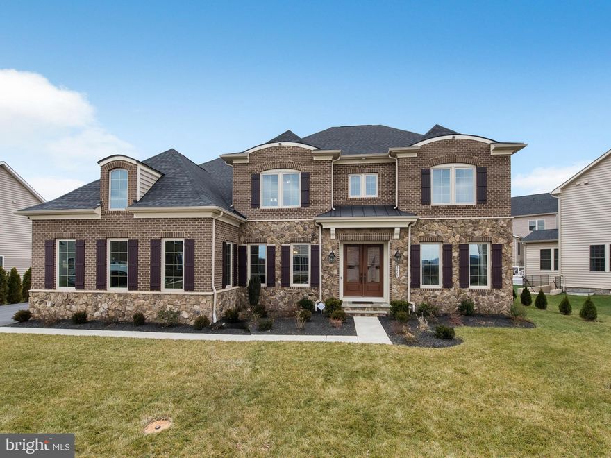 Fabulous NV home loaded w/options! Prof. decorated & shows like a model! Chef's kitchen, designer lighting, hardwds, granite throughout. 6 bedrms w/en suite baths. Main level bedrm & bath. Relaxing Master suite w/ coffee bar/bev. center. Entertainer's dream basement: bar, rec area, media rm, bedrm & full bath! Flagstone patio w/built in BBQ! 3 car garage. This home has it all! Blue Ribbon schools!