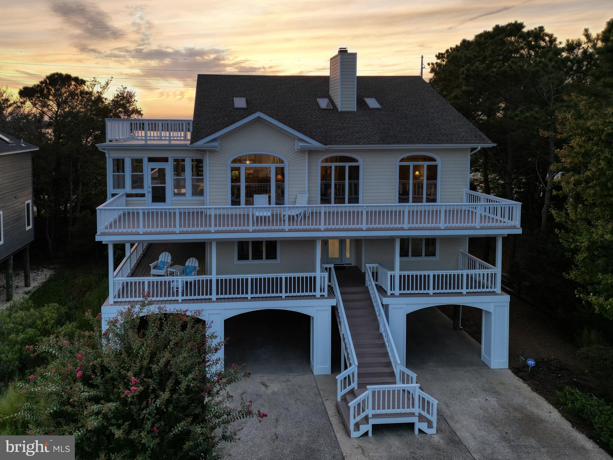 Located in one of North Bethany's most sought-after communities is where you'll find this well-maintained 5 bedroom (owners using one bedroom as a den), 4 full bath and 2 half bath home. Pull up and you'll be greeted by lush landscaping, ample paved parking areas and a curved driveway. Open the front door to a huge tiled foyer offering access to the downstairs family room with plush seating for a large group. In addition, there are two bedrooms with private baths and another bedroom with adjoining hall bath. Wander upstairs and be prepared to be wowed! Live and entertain in style. Bight open living/dining area with gleaming hardwood flooring and room for all your family and friends, wood burning FP for those cool beach evenings, and ceramic tiled kitchen featuring a large peninsula that seats 5 for casual dining and lots of neutral white cabinetry -- all open with views of the ocean and bonus views of the Salt Pond. The laundry room is just off the kitchen and features a convenient extra half bath -- take the back stairs, pop in, use the facilities, grab a cool water and head back and enjoy the sunshine. The primary suite offers a private bath with soaking tub and separate shower plus a walk-in closet. From the dining area, step outside and enjoy the side wraparound deck and is highlighted by stairs to an observation deck overlooking the area. The three-season sunroom is adjacent to the living room and adds great space to dine and relax. The front open deck spans the length of the house an offers room for sunning and relaxing with a cool beverage and spell-binding book. Ground level offers two outdoor showers with dressing areas, a foot wash and large shed for those beach toys. Located just steps from the life-guarded, private beach, this home has it all. Seabreak is a gated community with tennis and is an easy walk into town to enjoy all that Bethany has to offer -- restaurants, amusements, the boardwalk, entertainment and so much more. Surf, sea, sand - it can all be yours. You're not just buying a house, you're buying a lifestyle!