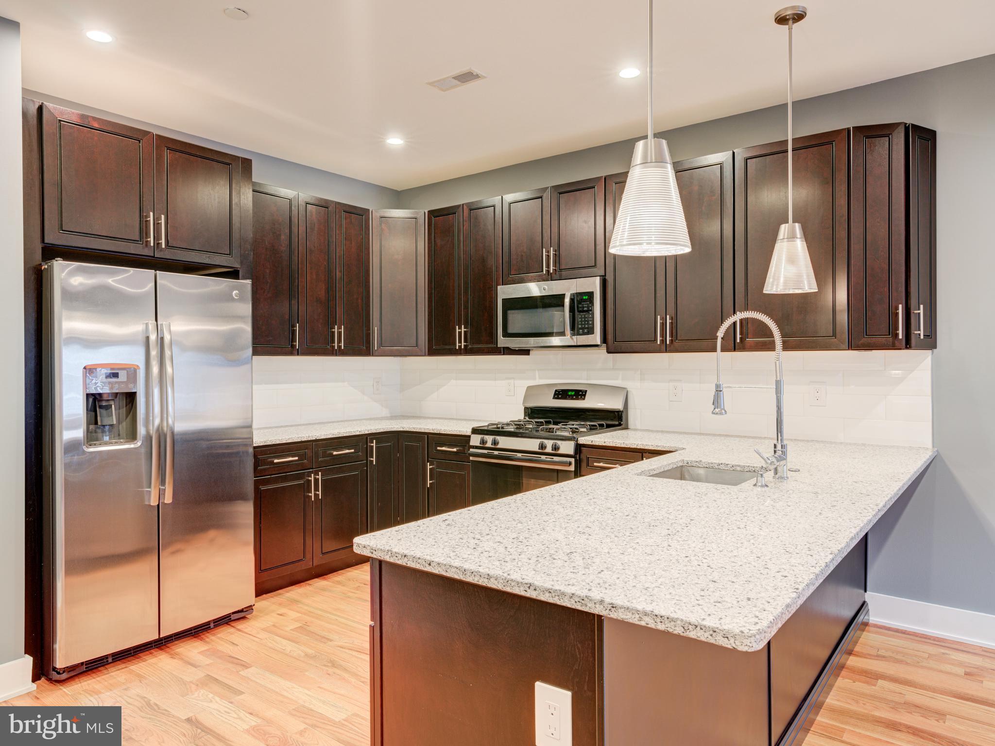 BEST location in South Kensington / Norther Liberties with PARKING and ROOF-TOP DECK ! Welcome to this stunning 3-bedroom, 3 full-bath custom-designed luxury condo in South Kensington, steps away from HOT Northern Liberties and walkable to Fishtown — all three being of Philadelphia's most vibrant neighborhoods. This is your chance to own a condo (which feels like a house) with private and coveted PARKING in the rear (surface space) with the huge benefit of affordability having approximately three years remaining on a tax abatement. Special features include a video doorbell system, a NEST thermostat, a cathedral ceiling, and custom blinds throughout. The open-air design creates a seamless flow between the spacious living, dining areas, and kitchen, with stunning oak hardwood floors, recessed lighting, and ceiling fans. The living room features a highly efficient fireplace, perfect for cozy winter evenings with modern open space. The chef’s kitchen is equipped with stainless steel appliances, an elegant quartz countertop, abundant cabinet space, and a breakfast bar. The first floor boasts a large bedroom and a full bathroom with exquisite ceramic tiles and a stylish vanity. Upstairs, the second floor features two generously sized bedrooms with ample closets, two full bathrooms with modern ceramic tile designs, and a master suite with a walk-in closet, a glass-door shower cabin, and a double vanity. A convenient utility room with a full-size washer and dryer is located next to the master bedroom. Take the stairs to your private roof-top deck, the perfect space to amazing city views, entertain guests, or watch 4th of July fireworks. Additional perks include a dog park conveniently located in the rear, easy access to public transit with a 10-minute walk to Girard Station (Market-Frankford Line), and proximity to the trolley and bus routes 47 and 57. The condo’s prime location has a walk score of 95, placing you near the restaurants, bars, and shops of Fishtown and Northern Liberties, with quick access to I-95 and I-676, and only a 1-hour, 10-minute train ride to New York City. The Layout is ideal for roommates as each bedroom has its own full bath or for the couple with kids or just wanting that private home office or guest bedroom. Don’t miss this rare opportunity to own a stylish condo with every amenity you need. Schedule your appointment today to view this extraordinary home as it is vacant and easy to show !