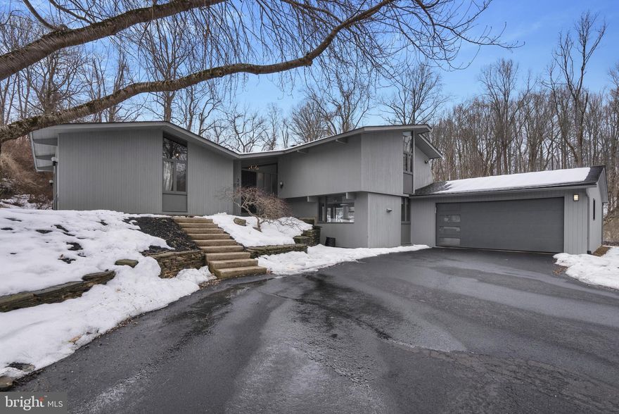 Welcome to this contemporary Acorn deck home located in the sought-after Unionville-Chadds Ford School District. Situated on a wooded cul-de-sac lot in Hanover Hunt, this 4-bedroom, 4-bath home offers well-designed living space with modern architecture and strong connections to the surrounding landscape. 
A private drive and mature trees provide a quiet setting while still offering convenient access to local amenities. The wooded lot delivers privacy and attractive views throughout the year. 
Inside, the open-concept floor plan features abundant natural light and distinctive architectural details. The great room includes vaulted ceilings, exposed beams, skylights, and large windows that overlook the property. A wood stove adds warmth to the main living area, and the layout allows for easy flow between the living and dining spaces—ideal for everyday living and entertaining. 
Wood flooring runs throughout much of the home. An entry-level bedroom offers flexibility for guests, a home office, or multi-generational living. A propane-fueled whole-house generator, installed in 2025, provides added convenience and peace of mind year-round. 
The backyard was renovated in Spring 2025 by GreenRoots Design Firm of Kennett Square, creating a functional outdoor patio space for dining and relaxing. Landscape lighting and a drip irrigation system add convenience and support ongoing maintenance.  
This is a unique opportunity to own a contemporary home with versatile space in a desirable Chadds Ford location. Schedule your private showing today.