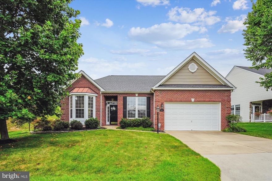 Welcome to Four Seasons at Historic Virginia, one of Prince William County's premier Active Adult Communities. Upon entering this popular Sequoia model, you're greeted by stunning hardwood floors that extend throughout the living room, dining room, and office/bdrm #3. Natural light fills the living room from the large bay window that overlooks the front lawn and from additional side windows that offer tranquil views  of the professionally landscaped yard and common area. The spacious dining room is seamlessly integrated with the living room, offering the perfect space for family gatherings. Beyond the dining room, the expansive family room features a cathedral ceiling with recessed lights and ceiling fan and a gas fireplace with marble surround and custom mantel. The family room opens to the gourmet kitchen featuring ample cabinet space, granite countertops, an attractive tile backsplash with stylish Listello accent, and a large island with breakfast bar. Enjoy a new GE French door refrigerator with interior water dispenser. A convenient breakfast room is just off the kitchen, and a sunroom, bathed in natural light, offers a tranquil spot to enjoy your morning coffee and it opens to a rear patio. 
The expanded primary bedroom is a luxurious retreat, complete with a comfortable sitting area and large walk-in closet. This room also features a sliding glass door that opens to the rear patio.  It offers plenty of space to relax and unwind. The attached ensuite bathroom features dual sinks for personalized convenience, along with a rejuvenating soaking tub and a walk-in shower. Two additional bedrooms share a full hall bath, with one bedroom featuring unique floor-to-ceiling bookshelves, making this room perfect for a home office. Step outside and you'll find your own private haven. Imagine quiet mornings enjoying breakfast on the patio or hosting a BBQ with friends in the backyard. The community offers resort-style living with indoor and outdoor pools, fitness center, tennis and pickleball courts, bocce ball courts, and a fabulous club house with lots of social events to enjoy. Cultural, dining, and shopping opportunities are nearby or take a 30 minute drive south and explore historic Fredericksburg. 30 minutes north and you'll be in Old Town Alexandria and all the trendy shops and restaurants the city has to offer. Recent updates include roof 2023, HVAC 2022, siding 2022, Refrigerator 2025, family room and primary bedroom carpet 2025, newer washer and dryer.