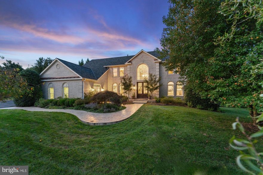 West coast meets East coast in this modern Vienna home with $600K in upgrades. This gated all brick home has 5 bedrooms, 4.5 bathrooms, 6,244 finished square feet and is sited on a premium 1.85 acre lot. It boasts an array of luxury finishes throughout this bright open floor plan that provides more than enough space for entertaining family and friends. Two-story foyer with curved staircase that opens to a formal living room and dining room. A chef’s dream kitchen showcases a center island with cooktop, granite countertops, dual refrigerator, wall oven, built-in microwave, and breakfast room. Grand two-story family room with skylights and a fireplace is the perfect space to relax, then step out onto the deck. The main level also features a large sunroom with skylights, Palladian windows, and easy access to deck, executive office with built-in bookcases, and half bath. Upper level features an owner's suite with a sitting room, and luxurious spa-like en suite bathroom with a dual vanity, soaking tub, and walk-in shower with frameless glass doors. Three additional bedrooms, a Jack and Jill bath, and one en suite bath on the upper level. Entertain in style in the walk-out lower level that features a large recreation room with an amazing full sized kitchen and table space, two refrigerated wine cellars, great for entertaining guests. In the lower level you will also find a bedroom, bonus room, gym, sauna, dog washing station, laundry room, and full bathroom. This 1.85 acre lot backs to trees for your own privacy with lots of potential in the backyard. Outdoors also features a large multi level deck, spacious patio, and fire pit for hosting barbecues with family and friends.  Close to shops, restaurants, and Lake Audubon. Easy access to VA-267, VA-123. Nearby Sunrise, Hughes, and South Lakes Pyramid.