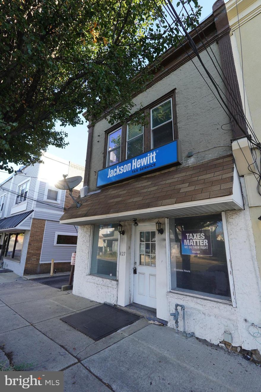 Investor Alert!  Income generating property!  Commercial 1st floor, formerly occupied by Jackson Hewitt Tax Service.: Features large open floor plan, 2 rear rooms and private bath,  access to basement for storage.  Many great uses for this space.  2nd floor features a 3 bedroom apartment with original hardwood floors,  eat in kitchen with laundry room off the kitchen.  Detached garage as added bonus.  Located on high traffic street with large municipal lot with parking for up to 28 cars.