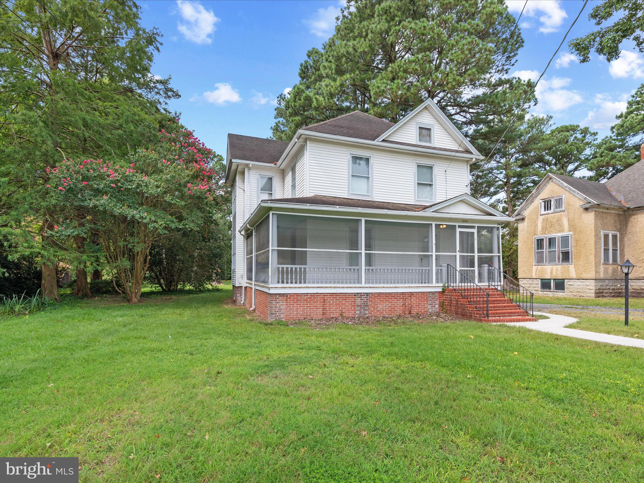 If you’ve been searching for a home with soul, charm, and a story to tell, something far from the cookie-cutter norm, this 1920s farmhouse is ready to capture your heart. Its timeless character begins with a brick foundation and welcoming steps that lead to a screened wraparound porch, perfect for a porch swing and lazy afternoons in the breeze.
Inside, the spacious living room greets you with beautiful wood banisters, a graceful staircase, and a stunning stained-glass window that catches the light. The flow continues into a warm, inviting kitchen with rich wood cabinetry, a double sink framed by a sunny window, and space for a cozy breakfast table. From here, a second staircase provides a charming shortcut to the upstairs. A formal dining room connects seamlessly, ready for gatherings big or small.
Upstairs, you’ll find the primary bedroom along with two additional bedrooms and a full hall bath. Each bedroom is complete with a ceiling fan, adding comfort. The first floor also features a large laundry room and a convenient powder room.
Outside, the large backyard offers space to roam, with mature trees providing shade and privacy. A roomy storage shed stands ready for hobbies, tools, or extra storage. This is a home that blends history, warmth, and everyday comfort in one inviting package.
Being sold partially furnished.