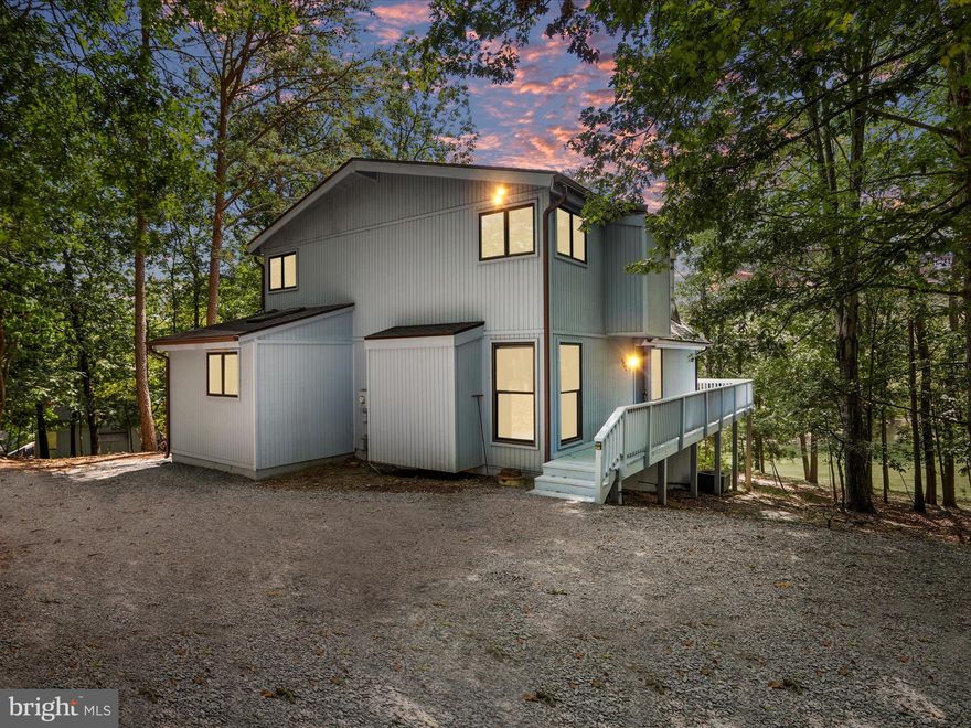 Elmwood Model | 3BR | 2BA |  1,706 Sq Ft | Furnished | Class A Membership Available Tucked into a serene, wooded setting with the feeling of total escape, this beloved Elmwood model is making its market debut after decades of meticulous ownership—and it's every bit the warm, light-filled retreat buyers hope for.
• Wraparound deck and immaculate screened-in porch offer year-round enjoyment and spectacular mountain views
• Vaulted ceilings in the great room and upstairs bedrooms flood the home with natural light
• Updated kitchen with newer appliances, custom cabinetry, generous storage, and a uniquely shaped breakfast counter
• The main-floor primary suite showcases a thoughtfully designed addition with a spa-inspired bath featuring a custom-tiled walk-in shower, skylight, jet tub, upgraded vanity, and convenient laundry.
• Updated second-floor guest bathroom adds fresh comfort and functionality
• Hardwood floors throughout the main living area and kitchen, with cozy carpeted bedrooms and stairway
• Multiple sliding glass doors connect indoor and outdoor living, inviting you to relax, entertain, or simply exhale
• Recent upgrades include new roof (July 2025), fresh exterior paint, partial siding replacement (2025), and a replaced grinder pump (Feb 2024).
Offered fully furnished and turn-key, this home is as move-in ready as they come. Window treatments convey. The gently wooded lot means low maintenance-no mowing, just nature.
Plus, there's room to add a garage if desired.
Includes eligibility for a Class A Membership to The Woods Club-your key to premier amenities including golf, indoor/outdoor pools, tennis, fitness center, and more. A one-time initiation fee of $3,150 applies, with annual dues of $2,600.