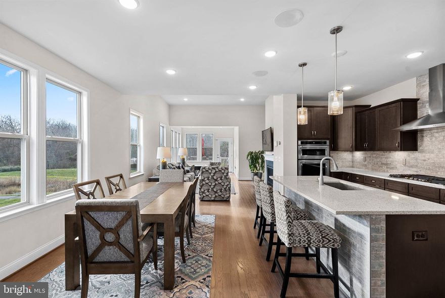 PRICE REDUCED! 
MAIN LEVEL LIVING!  Who needs an elevator when everything you need is on the entry level???  
PERFECT FOR MULTI-GENERATIONAL LIVING!

+ 55+ adult community villa
+ RARE END-UNIT with MANY WINDOWS and LIGHT!!!!
+ Nearly 4,000 square feet of thoughtfully finished space.
+ Stainless-steel appliances and quartz countertops .
+ Open-concept floorplan with engineered wood floors on main and upper levels.
+ Main level deck and lower patio 
+ Expansive views of the pond, open greenery, and woods
+ 4 generously sized bedrooms, each with its own en-suite bathroom. 
* Upstairs loft and office provide additional versatile spaces, perfect for a cozy reading nook or a productive work area.
+ Finished walk-out basement with 4th bedroom and full bath. Plenty of storage.
+ Basement has been pre-wired and plumbed for an extra full kitchen.
+ 240 EV outlet for electric cars
+ Surround sound and gas fireplace
+ Walking trail to Potomac River
+ 1 mile to One Loudoun
+ Easy access to Rte 7

Why pay high HOA fees for amenities that you will not use??  Consider a membership to use Ashburn Village's pool and gym/sports pavilion which is just 7 min away for the months you'll want a pool.