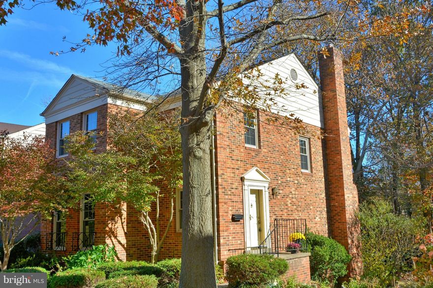 All Brick End Town Home. Charming kitchen with SS appliances & breakfast bar opens to FR with wood burning fireplace. Formal LR & DR. Lower lvl has 4th bedroom, full bath and rec room with beamed ceiling & wood burning fireplace + french doors that open to a large deck overlooking treed common area. 3 finished levels,4 Beds/3 1/2 baths. New paint and carpet, updated baths. Ample guest parking.