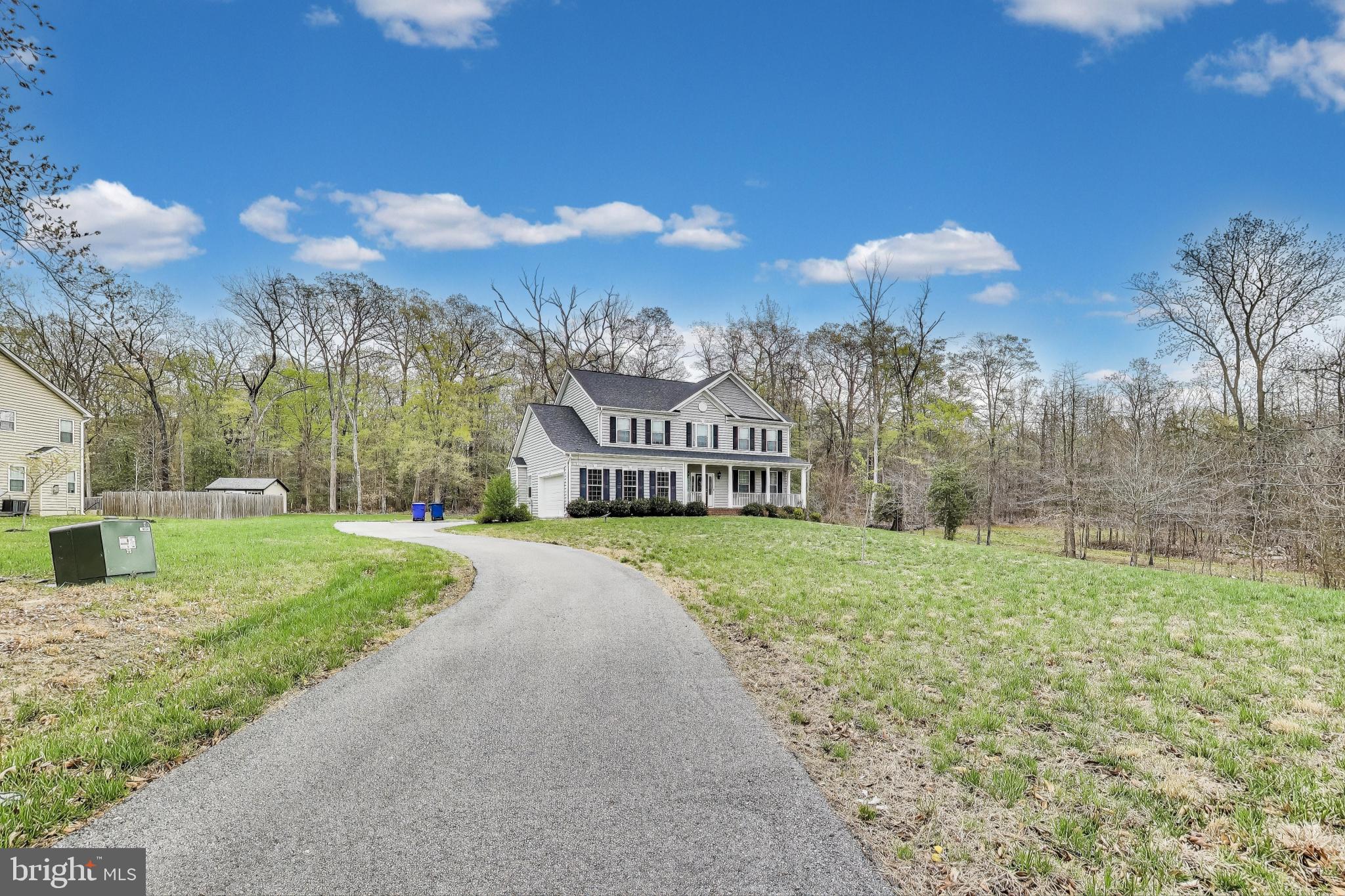 Welcome to your dream home, nestled on 1.2 acres in the picturesque Hunter Springs community of Indian Head, Maryland. Built in 2019 by the esteemed Quality Built Homes Inc., this property showcases premium upgrades and meticulous attention to detail throughout.
Spanning over 4,200 square feet across three fully finished levels, this 5-bedroom, 3.5-bath home is designed for both comfort and style. It features a whole-home security system, surround sound hookups in the living room, and a fully finished walk-up basement.
From the moment you arrive, the home’s charming front porch, manicured lawn, and mature landscaping offer outstanding curb appeal. Step inside to a welcoming foyer with luxury vinyl plank flooring that flows seamlessly through the main level. To your right, a light-filled living room with elegant crown molding sets the tone for gracious entertaining. The formal dining room exudes classic sophistication with detailed wainscoting, chair rail, and crown molding—perfect for hosting special occasions.
The gourmet kitchen is a chef’s dream, complete with granite countertops, stainless steel appliances, double ovens, a cooktop, and a large center island. Step out onto the rear deck—ideal for summer barbecues and quiet evenings with serene forest views.
The open-concept layout leads directly into the spacious family room, featuring a cozy fireplace with a stylish mantel—perfect for gathering on chilly evenings. Additional main level highlights include a powder room, a mudroom with access to the two-car garage, and plenty of functional space for everyday living.
Upstairs, retreat to the luxurious primary suite with a grand walk-in closet and spa-like ensuite bathroom, complete with dual vanities, an oversized glass shower, a resting bench, and a soaking tub. Three additional bedrooms, a full bathroom, and a convenient upper-level laundry room complete this floor.
The fully finished lower level offers a spacious recreation room, a fifth bedroom, a full bathroom, a utility room, and extra storage space—an ideal setup for guests, entertaining, or a home office.
Every inch of this home has been thoughtfully designed and lovingly maintained. With its modern upgrades, generous layout, and inviting atmosphere, this stunning property is a must-see. Welcome home!