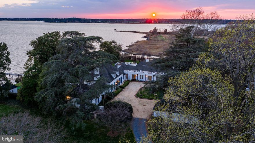 Willow Oak Farm is a rare and storied waterfront estate set on 20.0+/- acres along the shores of Harris Creek in Bozman, Maryland. Originally established in 1892, the property offers approximately 983 feet of waterfront and expansive open water views, with exceptional privacy just minutes from St. Michaels and Easton. The 6,000-square-foot French Eclectic main residence, built in 1921, features four en-bedrooms, grand entertaining spaces, and a seamless balance of formal and casual living. A separate cottage provides additional accommodations or workspace. Extensively renovated and modernized by the current owners, the home and infrastructure have been comprehensively upgraded while preserving historic character, creating a turnkey estate designed for both everyday living and refined entertaining.