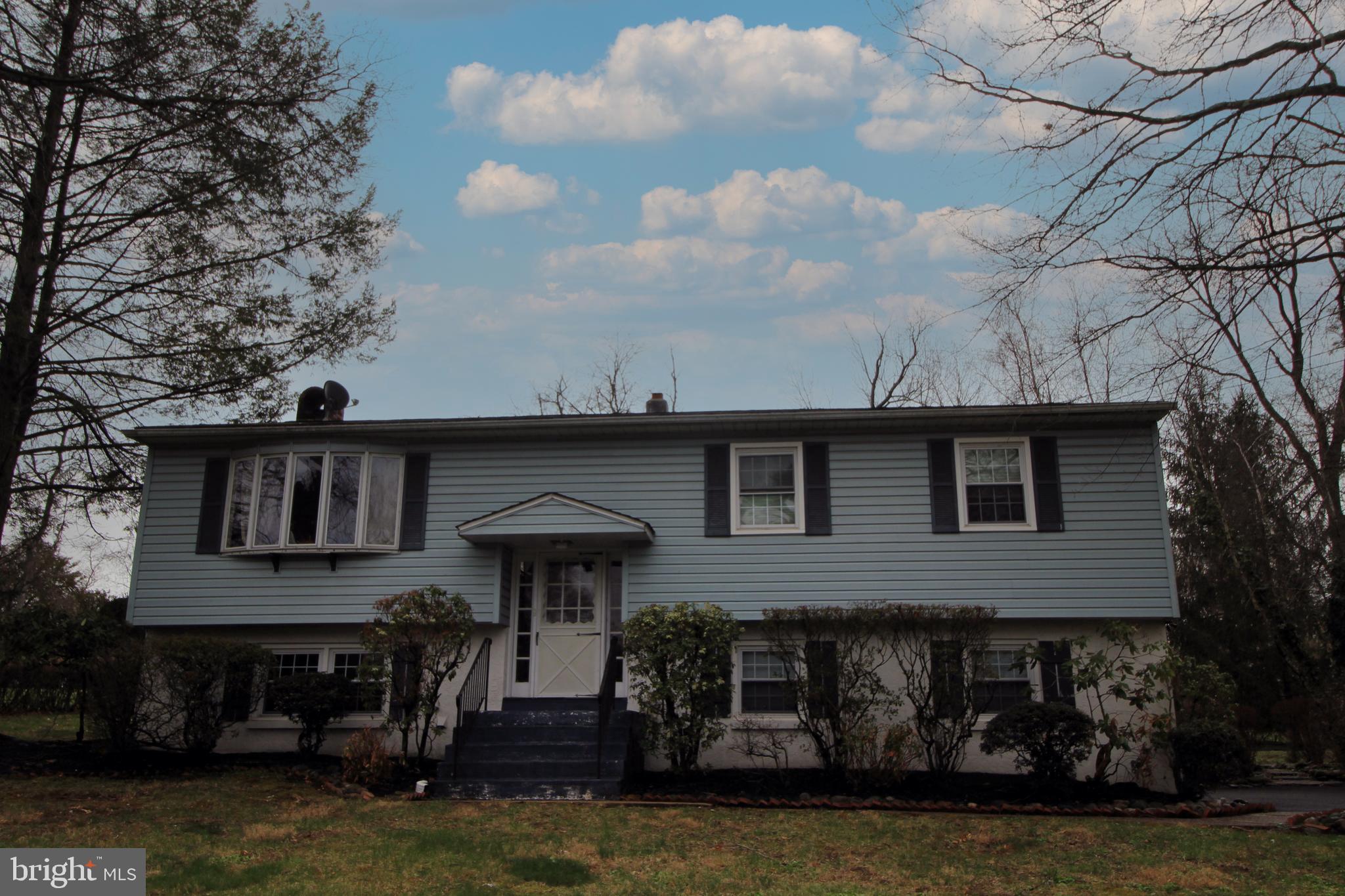 Spacious Bi-Level Home with In-Law Suite & Endless Potential! Located in the heart of New Hope with Blue Ribbon New Hope-Solebury School District, this bi-level home offers incredible potential for those seeking space, functionality, and a prime location. Featuring 3 bedrooms and 2 full bathrooms on the upper level, along with a fully equipped in-law suite downstairs with a separate entrance, this home is perfect for multi-generational living or rental possibilities. Upstairs, the bright and airy family room boasts cathedral ceilings, skylights, wood floors, and a sliding door leading to the deck, creating a perfect space for relaxing or entertaining. The formal dining room flows seamlessly into the kitchen, which features electric cooking, oak cabinets, and a tile backsplash. The lower level in-law suite includes a private kitchen, living room, bedroom, and full bathroom, providing complete independence and comfort. Situated on a spacious lot, this home also features a one-car detached garage, a shed, and plenty of driveway parking. Enjoy peace of mind with newer windows and completed septic, well water, and above-ground oil tank tests. A fixer-upper’s dream, this home is being sold as-is, offering the perfect opportunity to customize and make it your own. Don’t miss out on this fantastic investment in an unbeatable location!