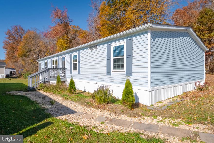 OPEN HOUSE THIS SUNDAY -- 12/21/25 from 11AM-1PM!! Beautifully renovated double-wide in the desirable Bush River Manor subdivision. This is a very spacious 4-bedroom, 2-bathroom home with a modern layout, in excellent condition with lots of storage space. Fully renovated this year (2025), including a NEW ROOF, hot water heater, HVAC, floors, windows, refrigerator, stove, and more. The laundry room is accessible from the master bath and the kitchen. Enjoy cozy evenings by the wood-burning fireplace in the inviting living area that could be a dining room or a second living/sitting room. Situated on a large corner lot which offers privacy in a serene outdoor space perfect for relaxation, surrounded by woods.  Additional highlights includes a parking pad for two vehicles and a shed for extra storage. The community has 3 additional parking pads for any guests/additional vehicles. The home has 3 access doors, including a sliding glass doors to the back yard, a front door to the porch, and door directly to the laundry room. This home is partially furnished, allowing for a seamless transition into your new space. Experience the perfect blend of modern living and nature in this exceptional home. The Lot rent includes trash - water and sewer can be paid in the same payment additional to lot rent.