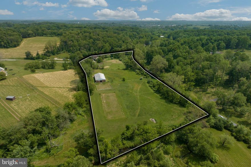 New PRICE!!!!!  A Little Piece of Heaven
Working Horse Farm for 40 plus years!
Welcome to 605 Wollaston Road!  
It is not easy to find 10 plus acres in Unionville-Chadds Ford School District that has all the attributes for horse lovers, those who want to teach riding, or for those who want to make the jump to four star status! 
The stone bank barn was built in the 1800’s; it is 60’ x 60’.  It has six stalls, a tack room, blanket room, feed room and a storage room that can be used for bedding, hay/straw on the main floor. There is hot and cold running water, too. The barn has a large hayloft and a sizable storage unit in the upper level that can be used as an office.  It also has lightning rods and a fire alarm system.  In addition, there is a three-stall stable with an attached storage area for farm equipment.  
The 4 BR, 2.5 bath home was made into a residence in the early 1900’s. It previously had been a Mill that was built in 1701.  There are two kitchens, one on the main floor and one on the lower level.  In additional to the kitchen, the main floor has a dining room and a living room, with a gas fireplace and a large picture window. There are four bedrooms on the second floor. The primary bedroom has a full bath, with a second full bath in the hallway.  Access to the attic is available through a drop-down ladder. The lower level has a family room, with a fireplace (a pellet stove set in the fireplace), and the second kitchen, with exposed stone, and deep walls. The laundry room is located on this level, as is the large sunporch. The house is equipped with a whole house generator and is connected to public sewer.
The property has a 50’ X 100’ indoor arena, with running water, electric and large mirrors.  The footing is a mixture of sand and rubber. The 70’ x 100’ paddock is accessible through the arena’s sliding door.  Beyond the indoor arena there is an outdoor Olympic sized dressage arena; substructure and stone footing are in place, insuring a flat, level surface. The arena is 66’ x 199’.
The property is very close to the renowned large animal veterinary hospital, New Bolton Center. The Borough of Kennett Square is a mere five-minute drive, giving access to wonderful restaurants, the new Kennett Library and fun shops. 
Living History
The building and farm have an interesting history. Once a grist mill, the house directly across Wollaston was the miller’s house. The pond just up the hill on the neighboring farm was once the mill pond.
The mill race for the water that powered the water wheel is still visible in places. It began just opposite the large farm on Street Road behind the listed property, where there was a weir damn constructed to divert water from the red clay into the mill race. The weir damn is still there but the stream has diverted around it.
The race runs roughly parallel to the front driveway, across the pasture on the south side of the house and eventually to the Mill. Beautiful stonework supporting the bank for the mill race is still there just upstream from the listed property. The race curves around the contour and into the mill. Traces are still visible. 
In the 17th and early 18th centuries milling was a profitable business, as evidenced by the great lengths gone to construct them. In this corner of East Marlborough Township the grist mills ground grains which were used to feed the lime kiln workers who lived in the village next to the kilns on the big property across Mill Road to the west of the listed property. 
All that’s left of that little village is the schoolhouse. It also went to feed the workers living at Willowdale, whose industry was charcoal for the iron smelting over by the Laurels near Doe Run. Willow makes excellent charcoal. 
It was a profitable but short-lived time here. The kilns petered out when steam power arrived, and water wheels became obsolete.
This house Is NOT in the flood zone!
Make your appointment today!!!