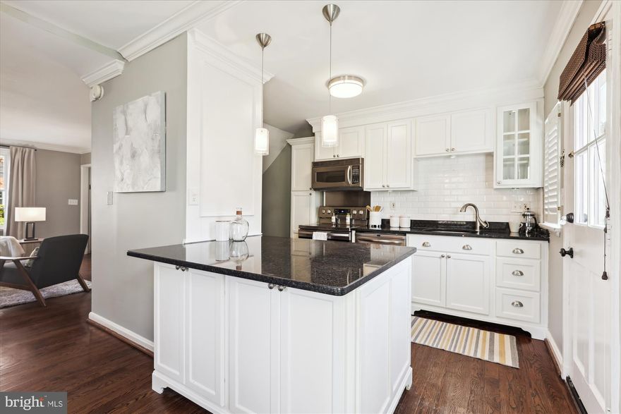 Gorgeous and RARE 3-bedroom, 3-bathroom Dominion model home in Fairlington Commons! The light-filled main level of this end-unit boasts updated hardwood flooring, crown molding, and neutral paint throughout. The updated open kitchen features white custom cabinetry with a tall pantry cabinet, granite countertops, a subway tile backsplash, stainless steel appliances including a newer stove (2022), dishwasher (2021), refrigerator (2021), & NEW disposal (2024), and a movable kitchen island with pendant lighting. The spacious dining area is highlighted by frame molding and a transitional-contemporary chandelier. Both the kitchen and dining area overlook the HUGE fully fenced back patio with brick and stone pavers plus a storage shed - perfect for entertaining!

The beautiful hardwood flooring extends up the staircase and flows through the upper-level hallway and bedrooms. At the top of the stairs, a modern chandelier illuminates the hallway outside a full bathroom featuring LVP flooring, crown molding, a white stone-topped vanity, a large medicine cabinet mirror, and a sparkling white subway-tiled shower. The rare primary suite includes a spacious bedroom with a generous closet and a French door leading to the en-suite bathroom, which offers custom black-and-white tile flooring, crown molding, a dual stone-topped vanity, contemporary lighting, a subway-tiled shower, cabinet storage, and a wardrobe that conveys. A second bedroom with views of the picturesque common grounds and walking path completes this level.

Carpeted stairs lead to the lower living level, featuring updated flooring throughout. The spacious recreation room includes wainscoting, updated door trim, recessed lighting, a built-in under-stair wine refrigerator, and ample storage! The HUGE bonus room - commonly used as a bedroom or a home office - offers a dual-entry walk-in closet (also accessible from the rec room hallway) and a full bathroom with a pedestal sink, medicine cabinet mirror, white tiled shower, and a laundry nook with full-sized newer Maytag washer & dryer (2022) plus overhead shelving. Other home features include a newer water heater (2021), a large floored attic with extra storage space, and 2 parking passes for use in ANY Fairlington Commons lot. Community amenities include a pool, tennis courts, tot lots, walking paths, & MORE! Great location - just a short walk to the Fairlington Farmers Market & state-of-the-art playground, a quick & easy commute by bus or car to Amazon HQ2 & DC, and close to the shops & restaurants in the Village at Shirlington, Del Ray, & Old Town!