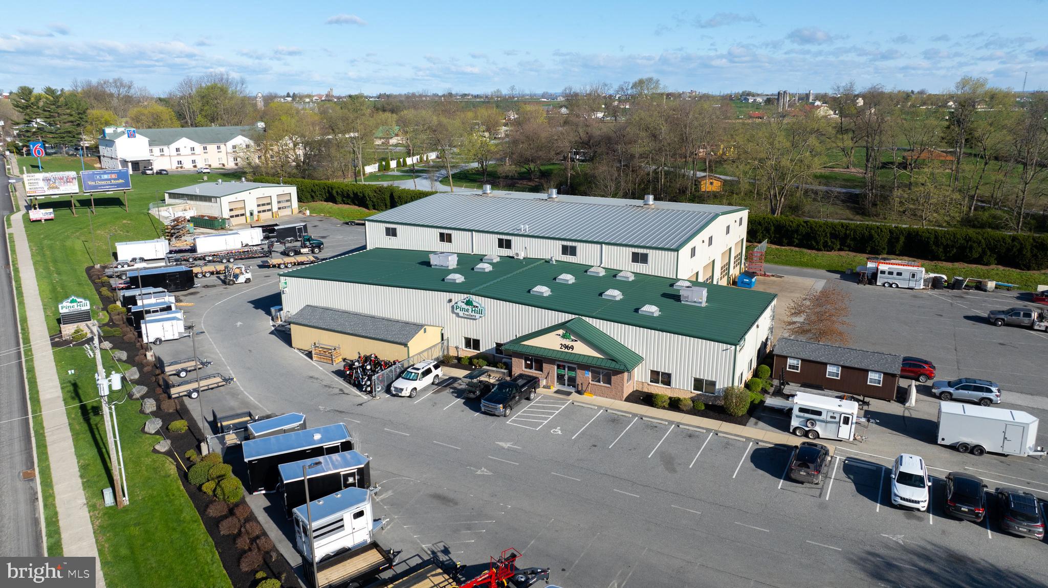 2975 Lincoln Highway East (Tax Account #310-04516-0-0000) also included in sale price. Property is currently production and sales facility for Pine Hill Trailers, which is relocating. Site contains 3 warehouses and 1 house. Area for trailer parking, outside storage or additional building capacity. Great visibility along Route 30.