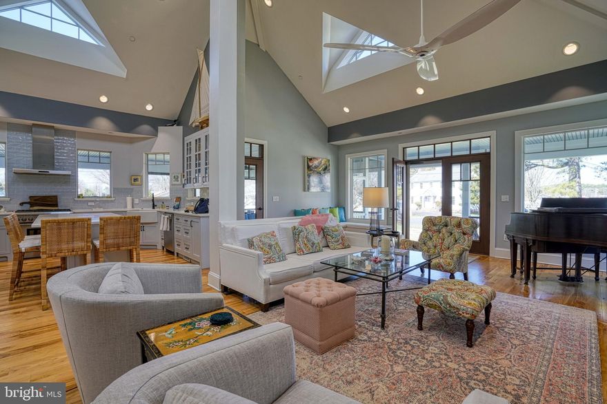 Welcome to "Mostly Porches" an exceptional coastal retreat with captivating views of the harbor, perfectly situated on a spacious .41 acre corner lot just around the corner from the shops and restaurants of St. Michaels.  Built in 2018 with virtually maintenance-free construction, this beautifully designed home offers the ideal blend of comfort, style, and convenience in a rare St. Michaels setting.
Inside the floor plan is filled with an abundance of natural light and enhanced by soaring cathedral ceilings, creating an airy and inviting atmosphere ideal for both every day living and perfect for entertaining.  The main living area incorporates the living, dining and kitchen and offers easy access to the extensive porches the home features, including the screened-in porch with a gas fireplace and views of the harbor.  In the great room there is also a "hidden" pantry along the dining area wall with plenty of shelving and storage.  Custom built-in bookcases line the living area wall to the left of the propane fireplace which incorporates a built-in 90 lb per day nugget ice-maker.  The gourmet kitchen is centered around a large island and features SS Thermador appliances including a duel fuel range with a six burner gas cooktop and electric oven, and an under counter wine fridge and under counter beverage fridge in the island.  The contemporary design features the primary suite, 2nd bedroom, office/den, full bath and utility closet all on the main level.  A standout out feature of this property is the 2nd level private guest suite, which is a licensed income-producing vacation rental, offering flexibility for guest or the opportunity for supplemental income.  This private enclave includes a small sitting area, private bath and kitchenette with  under counter refrigerator drawer, under counter freezer drawer, Keurig coffee maker, counter top microwave, and free standing shelves.  The property also includes an attached 2 car garage, fire pit, raised garden beds with drip irrigation, and full irrigation system in the yard plus an oversized attached 2 car garage.
With its desirable location close to all St. Michaels has to offer, exceptional amenities, and low-maintenance design, this is a rare opportunity to own one of the town's newer build homes with water views and income producing opportunity.