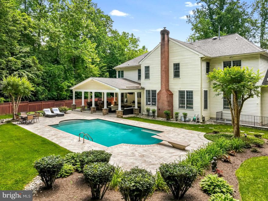 ABSOLUTELY STUNNING 5200+ sf ESTATE HOME with a SHOW STOPPING ENTERTAINER’S DREAM BACKYARD featuring a HEATED IN-GROUND SALTWATER POOL, HUGE COVERED PATIO with CUSTOM OUTDOOR KITCHEN (the granite and stone bar seats 12 people), GAS FIREPIT, BUILT-IN OUTDOOR TV, CUSTOM 11' OUTDOOR BUFFET and HEATERS on one of the best lots in the desirable Crownsville community of ANNAPOLIS PRESERVE.  EXQUISITE CURB APPEAL!  This 4 Bedroom, 4.5 bath, 3 car garage property is spectacular and has over $500,000 of renovations and upgrades. A tech lover’s dream: Smart Apps Remote Controlled Heating/AC, garage doors and pool heater from anywhere with a touch of your phone.  The "Pebble Tec" SALTWATER POOL features over 2500 sq ft of PORCELAIN TILE DECKING, GORGEOUS LANDSCAPING with irrigation system, EXTERIOR LIGHTING, STONE TERRACE RETAINING WALLS and more. The oversized  RENOVATED KITCHEN with CUSTOM CABINETRY TO CEILING is perfect for entertaining, featuring a large island with MARBLE COUNTERS, custom backsplash, Sub Zero Refrigerator, Viking 4 burner + grill gas cooktop, Viking Double Induction Oven with Warming Drawer, Kitchen Aide Dishwasher, Custom Built-in Bar with sink and Perlick Entertainment Refrigerator, Under Cabinet Lighting and custom built in PANTRY. The GRAND CONSERVATORY found on the far-left side of the home features wall-to-wall PALLADIAN WINDOWS and can be used as a game room or converted into a guest suite, if desired. The large FAMILY ROOM found next to the kitchen hosts a WOOD-BURNING FIREPLACE and overlooks the gorgeous backyard oasis. The LIBRARY/HOME OFFICE has custom built-in cabinetry and gleaming hardwood floors. The oversized FORMAL DINING ROOM and LIVING ROOM are the perfect spaces to host your dinner parties with family and friends. The second level of the home has 4 LARGE BEDROOMS – all with ENSUITE BATHROOMS.  The expansive OWNERS' BEDROOM features a sitting area, tray ceiling and large walk-in closet with Custom Built-in Cabinetry. The renovated OWNER’S BATHROOM is a showcase of technology: No need to waste time getting the perfect water temperature; 2 Kohler Digital shower panels allow you to program your preferred temperature and 12 SHOWER HEADS with a touch of a button.  The 14’ vaulted Custom Glass Shower also includes a Digital Wet Sauna with granite seat. The primary bathroom also has Heated Tile Floors (programmable digital control panel), Dual Vanities, a separate Large Vanity Makeup Area, Vanity Mirror TV (is a must see), a Jacuzzi Jet Tub, Granite Countertops and Cherry Wood Cabinetry. Three more large bedrooms with three ensuite bathrooms and walk-in closets complete the second level. 
BRAND NEW ROOF and DRIVEWAY.  All Hardscapes (front & Rear) were Renovated / Replaced in 2022- 2023. The UNFINISHED WALK-UP BASEMENT features two sump pumps and more than 2500 sq ft of space to finish anyway you wish! This property also includes an oversized, 3-CAR, SIDE-LOAD GARAGE with extra parking in the over-sized paved driveway. WHOLE HOUSE GENERATOR conveys with home.  No need to shop for furniture. This home has an option to purchase any or all of the home furnishings on a separate bill of sale. The community playground/tot lot is just a stone’s throw away. Only minutes to downtown Annapolis, major commuting routes to Baltimore and Washington, DC and convenient proximity to three major airports.