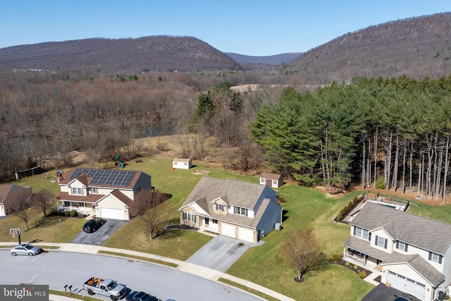 They say life is better with a view! Enjoy peaceful mountain views from the comfort of this 4 bed/ 2.5 bath home situated on a prime lot. This small community with no association fees is located within walking distance of Swatara rail trail.  Inviting living room is highlighted with an impressive vaulted ceiling, classic built in shelving, and a warm gas fireplace focal point complete with mantle.  Timeless hardwood flooring flows smoothly from the living room into the dining room through glass French doors.  Formal dining room is complimented with chair rail and crown molding.  The combination kitchen/family room provides an ideal gathering spot perfect for entertaining.  Kitchen boasts attractive tile backsplash, ample counter space, and a comfortable breakfast bar peninsula.  Appealing floor plan transitions easily from the kitchen to the family room and continues to flow gracefully to the outdoor entertainment area.  Enjoy the view of the mountains as the sun sets from the comfort of the bubbling hot tub and the shade of the gazebo complete with bar seating and a breezy ceiling fan.  The second floor primary suite provides a relaxing retreat including a private bath with a jetted corner tub plus a separate shower.  Three additional roomy bedrooms and another full bath with jetted tub/shower complete the upper level.  From the welcoming covered front porch to the enticing back yard with a view, this house is the complete package!