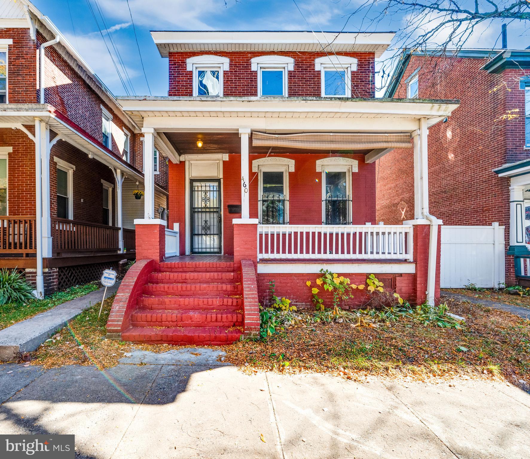 This classic 4-Bedroom Home, nestled on a beautifully treed lot, offers the perfect blend of indoor/outdoor space, location and charm, within close proximity to local parks, YMCA and much more! As you approach the property, you'll be captivated by its impressive curb appeal, composed of a vivid red brick and quaint covered front porch ready for a rocking chair and your favorite beverage. Step inside to discover a spacious living room, featuring a cozy central electric stove with brick surround. Wood floors flow throughout as you continue into the stunning kitchen which offers a bevy of counter space with beautiful glass-front upper display cabinets. From here, French doors open right up to the back deck with rear parking and a gorgeous mature tree that provides seasonal shade and beauty for your outdoor enjoyment. Each bedroom is generously scaled and feature ceiling fans for added comfort, and a main bath highlights a contemporary tiled shower/tub combo. Great space throughout with electric heat. Prepare to be WOW-ed when you pull up to this home! A new sump-pump and drainage was installed in December of 2024 and has a lifetime warranty. *A general home warranty is being provided by the seller with an acceptable offer* buy with confidence! *Please note that some photos are virtually staged*