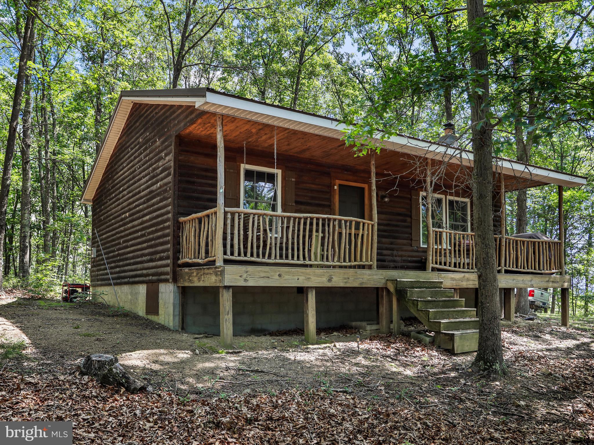 Here is your chance to own that private off grid living deep in the woods or hunting camp for you and your friends with plenty of Deer, Bear and Turkeys to keep you entertained. Nestled in a serene wooded setting, this charming cabin-style home with covered front porch invites you to experience the warmth and comfort of rustic living. With its log siding and stick-built construction, this residence exudes a cozy, lodge-like ambiance that feels like a retreat from the everyday hustle and bustle. Step inside to discover a space that is perfect for relaxation and gatherings. The inviting wood flooring flows throughout. Elegant kitchen with gas stove. A delightful fireplace serves as the heart of the home, offering a perfect spot to unwind with a good book or enjoy intimate conversations on chilly evenings. Don't miss out on this opportunity to make this cabin your own! Couple things to note, there is no water source or electric run to the house but there is a working septic field. The second bedroom still needs the wood ceiling trim finished. More/better pictures to come. Please do not attempt a drive by as the gate to the road is locked and requires an agent to be present.