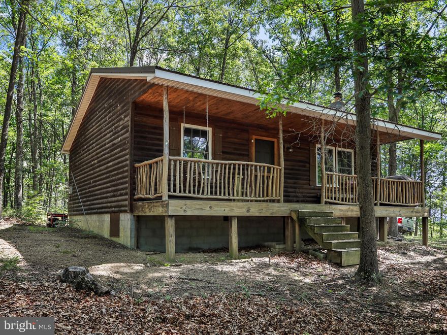 Here is your chance to own that private off grid living deep in the woods or hunting camp for you and your friends with plenty of Deer, Bear and Turkeys to keep you entertained.  Nestled in a serene wooded setting, this charming cabin-style home with covered front porch invites you to experience the warmth and comfort of rustic living. With its log siding and stick-built construction, this residence exudes a cozy, lodge-like ambiance that feels like a retreat from the everyday hustle and bustle. Step inside to discover a space that is perfect for relaxation and gatherings. The inviting wood flooring flows throughout. Elegant kitchen with gas stove. A delightful fireplace serves as the heart of the home, offering a perfect spot to unwind with a good book or enjoy intimate conversations on chilly evenings.  Don't miss out on this opportunity to make this cabin your own! Couple things to note, there is no water source or electric run to the house but there is a working septic field. The second bedroom still needs the wood ceiling trim finished. More/better pictures to come. Please do not attempt a drive by as the gate to the road is locked and requires an agent to be present.
