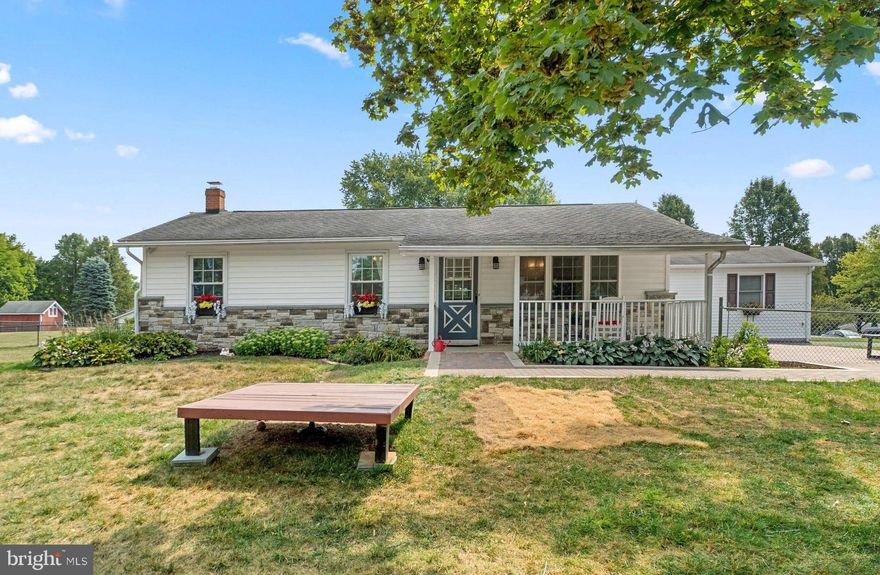 Situated on a .57 acre corner homesite in Darby Luxe you find this stone accented rancher boasting over 1,798 sqft, a dual heating and forced hot air system, an abundance of natural light and cross breezes, a bonus finished lower level, and a recently laid brick paver patio.  A charming covered front porch ushers you inside to be greeted by hardwood floors, a dining room showing a chandelier with a ceiling medallion, rich hardwoods,  central kitchen, and a living room with a trio window capped by a lunar window, a drop fan and architectural angled ceiling.  Cool ceramic tile lines the cook’s delight kitchen boasting GE and KitchenAid stainless steel appliances, Shaker style cabinetry, ample counter and prep space, a double sink, and space for a breakfast or bistro table.  Adding to the livable areas is the lower level highlighted by a rec room, a full bath with a vessel sink, a great amount of storage, and a walkout to the fenced backyard.
