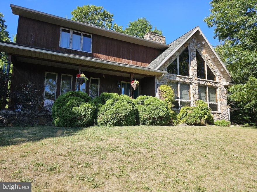 Welcome to 15007 Clement Armstrong Road, a stunning 3 bedroom, 2.5 bath home nestled on 2 acres of serene land.  This beautiful home with 2,584 square feet of living space providing ample room for comfort and relaxation.    The home is constructed with elegant stone and cedar, this home exudes rustic charm and timeless appeal.  The cathedral ceilings create a sense of spaciousness and grandeur while the stone gas fireplace in the living area offers a cozy focal point for gatherings and beautiful views out the front of the property, just one of the many standout features of this home.  The sunroom off the kitchen and family room in the back of the home boasts windows on all three sides providing panoramic views of the Dans Mountain Wildlife Area.  This bright and airy space is perfect for enjoying your morning coffee while watching the local wildlife or for unwinding with a book in the afternoon sun.  The kitchen retains its classic charm and adjoins a spacious family room.  This layout is ideal for creating a warm and inviting atmosphere, making it the heart of the home where family and friends can gather.  Situated at the edge of the Dans Mountain Wildlife Area, this home is perfect for nature lovers and outdoor enthusiasts.  Enjoy breathtaking views and the tranquility of the surrounding wilderness right in your backyard.  The expansive grounds offer endless possibilities for gardening, outdoor activities and more.  The spacious interior features a well-designed floor plan with a large living area, a dining space perfect for entertaining, and three generously sized bedrooms, providing a comfortable retreat for everyone in the family.  The primary suite includes an en-suite bathroom, while the additional 1.5 baths ensure convenience for guest and families alike.  Enjoy the lovely views while on the front porch of the home.  There is also additional space  in the very large unfinished walkout basement waiting for the finishing touches. Located just 10 minutes from downtown Cumberland - train rides, hiking and biking trails, restaurants, shopping and an hour away from Deep Creek Lake and the Wisp Ski Resort, this home offers easy access to year-round recreational activities, including skiing, boating, biking  and hiking.  Additionally, its strategic location on the Maryland, West Virginial, and Pennsylvania border provides convenient access to the amenities and attractions of all three states. Experience the perfect blend of peaceful country living and proximity to outdoor adventures .  This property is a true gem, offering a unique lifestyle opportunity in a beautiful setting.  Professional photos are coming - the photos included are previous photos taken of the home. Don't miss the chance to make this your dream home!