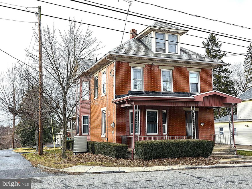 This exceptionally maintained 3 story is classic & timeless from it’s brick exterior and slate roof to the glistening hardwood floors, stained trim & woodwork and beautiful stained glass window in the foyer! Space abounds in this 3 bedroom 1.5 bath home with over 1,700 finished square footage plus a walk-up attic can be finished for future expansion.  This exceptional home which has been in the same family since being built and features many updates including a new boiler 2 years ago, heat pump with central air conditioning, modern replacement windows and more.  Outside you’ll find an expansive rear deck and FOUR GARAGE BAYS! Even better…INSTANT EQUITY!   This home just appraised in November 2025 for $265,000!  Don’t delay, schedule your showing today!