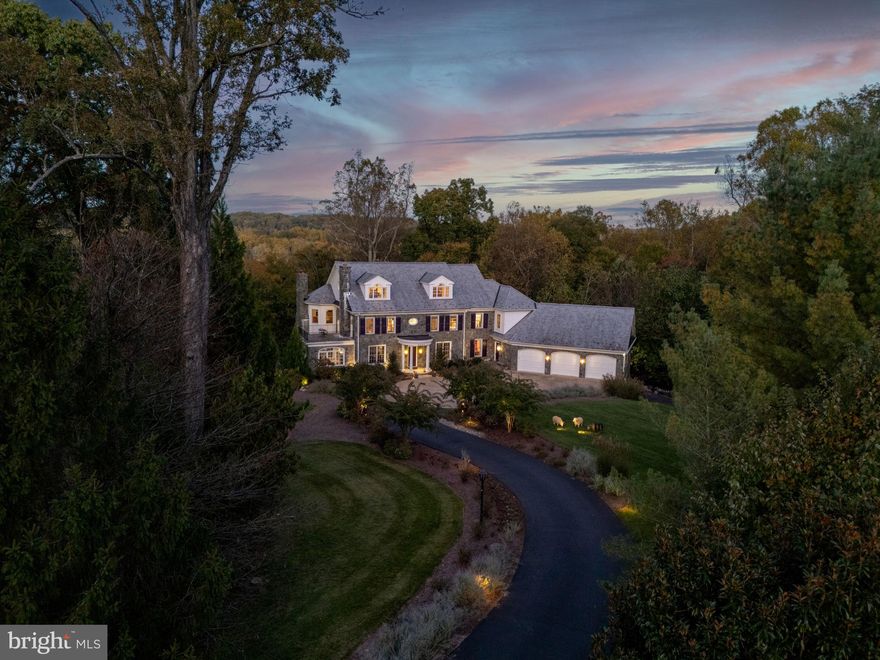 AMAZING OPPORTUNITY TO LIVE ALONGSIDE THE POTOMAC! Seldom available for rent, this spectacular, custom Potomac River retreat on almost 6 gently sloping acres located at the end of a cul-de-sac of only three homes (not part of an HOA) adjacent to highly-coveted the Falcon Ridge neighborhood. First time on the market and only 12 years young, 9884 River Chase was designed & built for its owners by notable builder Jim Kennerknecht and acclaimed Monarch Custom Homes to exacting standards with no detail overlooked. Spanning four large yet well-scaled levels, this home incorporates almost 7,900SF of finished space and more than 4,000SF of unfinished - totaling almost TWELVE THOUSAND SF. Carolina fieldstone welcomes visitors through an impressive center hall with large public rooms, hand hewn oak hardwood floors, high ceilings, custom casings, built-ins, deep crown/baseboard mouldings, oversized windows and doors, and many more upgrades that are to be expected in an offering of this caliber. Gorgeous honed marble kitchen with an oversized single-slab island, Wolf/Sub-Zero/Asko/Bosch appliances, adjacent pantry, butler's service bar & additional shelved food "closet" means this kitchen competes handedly. Wall of windows & glass doors open to elevated patio above the rolling hills overlooking the Potomac & Maryland beyond. Stone hearth & wood-burning fireplace in large family room make for a cozy atmosphere in an otherwise substantial home. Two opposing main level offices are perfect for today's working needs. Upstairs are 3 large bedroom suites each with attached full baths, laundry room, the upper level of the 2-story library/den, and the enormous, rear-facing primary suite with two attached full, spa-like baths, two walk-in closets, and bedroom with FP (one of 3 total). Finished, large attic level - currently a game/play area - offers huge space, half bath (changeable to full), built-ins & good storage. Lowest level has impressive custom wine cellar with reclaimed wood door & shelving, bedroom, full bath, and 45' indoor freshwater lap pool with wall of French doors that open to the loggia/covered stone terrace overlooking grassy, landscaped hills as they descend toward the water (with full ownership to 1' beyond the Potomac's shore). The RARE 2-level garage holds 5-6 vehicles (3 standard bays on main level; 1 back-to-front bay holds 2-3 on lower level) and includes a Tesla & additional car charging station...providing the auto collector's dream scenario. Ashley Elevators lift serves all 4 levels, 4-zone HVAC, tankless water heaters, whole-home generator, multi-zoned irrigation, upgraded pool room dehumidifier & more. With a 10-minute drive to Great Falls Village, 20 minutes to Tysons, 25 minutes to Dulles International Airport, 30 minutes to Downtown Bethesda and 35 minutes to The Kennedy Center, this impressive offering in an idyllic, river-side setting is still convenient to most of Metropolitan Capital Region. ONCE-IN-A-LIFETIME OPPORTUNITY - and check out the property video including drone aerial of entire property.