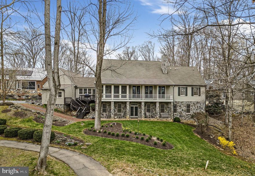 Truly Extraordinary.
This uniquely designed, impeccably sited home has all the essential elements of a welcoming effortless home. Located on a private cul-de-sac, tucked in Fernbank on Cress Creek, this custom-designed home overlooks the Potomac River and the 4th Green of Cress Creek Golf Course in Shepherdstown, WV. The Dutch Colonial-style farmhouse exudes an effortless grace while every detail has been carefully planned. A natural stone path leads to the front porch, where durable and beautiful Brazilian Ipe floors welcome you home.  Inside, quarter-sawn white oak floors flow throughout the main level.  The welcoming living room with stone hearth and gas logs, built-in cabinetry, and wood beam details welcome guests to relax and enjoy. The formal dining room shares the space and includes an additional built-in China cabinet and three French doors leading to the open-air back porch overlooking the lawn and the wide curve of the Potomac River. A wet bar area connects the dining room with a copper sink and custom cabinets. The gourmet kitchen will take your breath away; granite counters, Thermidor Professional 6-burner range with dual oven/cooktop/grill, cabinet panel Thermidor refrigerator, Bosch dishwasher, and warming drawer. A walk-in pantry with custom built-in shelving adds to the well-designed layout of the kitchen. Plantation shutters accent the kitchens eat-in area with a 6-person banquette and built-in desk and open to the screened porch. The screened porch is a room of its own. Brazilian Ipe hardwood runs out from the house to tie this room, overlooking the 4th Green, to the rest of the home. The primary bedroom suite is also on this level with a walk-in closet, a large ensuite with a walk-in shower and soaking tub, and dual vanities with custom cabinetry. There is also a private office, powder room, and laundry room on this level. On the lower level, an entire additional home awaits! The Family Room with a stone hearth and gas log fireplace creates a cozy corner for a game. The built-in entertainment center invites you to relax and unwind. The kitchenette with refrigerator, microwave, and dishwasher also accesses the double-doored wine cellar with cedar wine racks. The three additional bedrooms on this level each have ensuite baths. An office/craft room and great closet space are also a feature here. The rec room walks out to the gracious stone lower-level patio area. Every detail of this home- from the welcoming front porch to the interior details, to the relaxing screened porch designed as an additional room, the award-winning architect, David Jones and the sellers, planned for it all. With too many extraordinary details to list, this is a must-see property on the Potomac River.