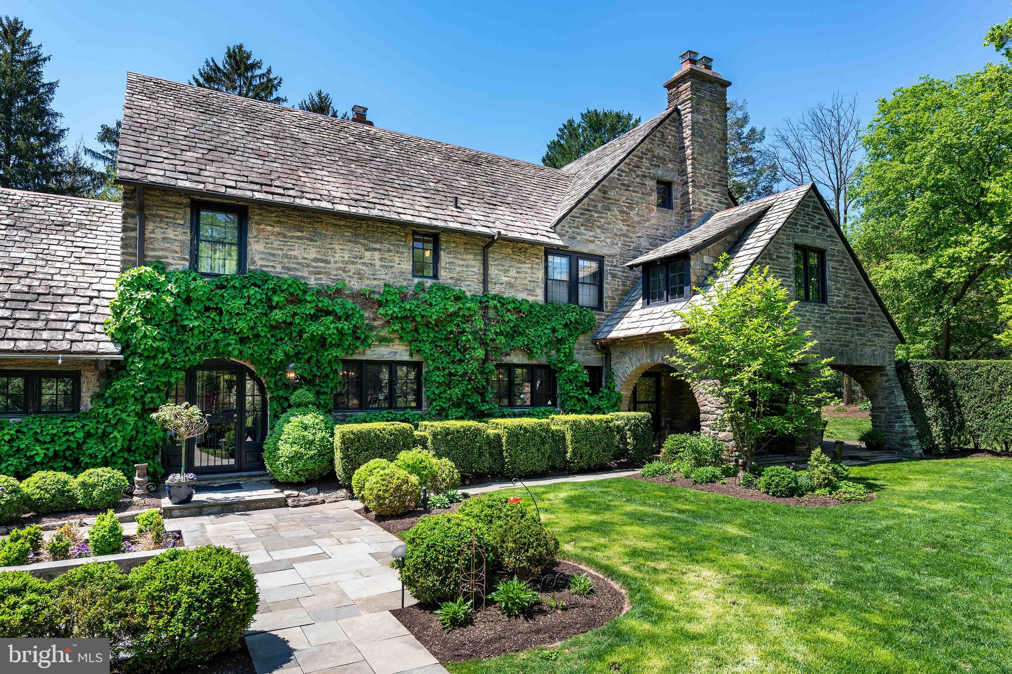 Elegance awaits you, inside and out, at this majestic, West Mount Airy Revival built in 1925. Enter a gracious foyer with stunning staircase, all designed with mahogany, walnut and oak woods. The first floor offers a gourmet, custom kitchen outfitted with SubZero and Dacor appliances, and french doors opening onto a fantastic terrace designed for summer entertaining. Enjoy beautifully proportioned dining and living rooms, both with fireplaces. The family room, with cathedral ceiling, is a cozy gathering place and the sunporch currently serves as an office. The second floor features a fabulous master suite with an ample sized walk-in closet and brand new, spectacular master bath. Additionally at the top of the exquisite second floor stairs are three bedrooms, one with en suite bath and two with jack and jill bath. Secluded study/office completes the picture. The third floor offers two more bedrooms with hall bath. Lots more storage space in the attic. 7220 Sherman is anchored by a finished basement with a carved fireplace and murals from Philadelphia's famous Red Rose Girls, a prohibition-era bar and brewing room and plenty of space for workout equipment and storage. This is an architectural wonder on a coveted, quiet street offering an outside as unique as its inside. Gated, mature landscaped exteriors, stone walls and patios abound. 2-car heated garage. This picturesque home makes a statement with its elegance and is move-in ready just for you! Walk to the train, the Wissahickon Trails, and a short drive to Mount Airy and Chestnut Hill shops, restaurants and Center City
