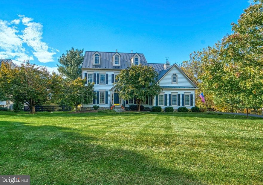 Welcome home to this stately Wetherburne Amherst Colonial, ideally located within the Mount Gilead Hamlet Community. Thoughtfully updated throughout, this exceptional home blends classic elegance with modern luxury. At the heart of the home is a completely renovated, chef-inspired kitchen featuring a custom butcher block island, genuine slate countertops, ZLINE 48" gas cooktop, GE Café double French-door wall oven, Samsung Bespoke refrigerator, ZLINE dishwasher, and a Fireclay 10" deep farmhouse apron-front sink. Custom shiplap, glass shelving, designer chandelier, and wall sconces complete this stunning space—truly a gourmet kitchen built to impress. The main level showcases new windows and sliding doors along the rear of the home, flooding the living spaces with natural light, and offering serene views of the Blue Ridge mountains and private backyard. Enjoy breathtaking sunsets from the kitchen, family room, or the expansive new Trex deck with updated railings and extra-wide steps. Outdoors, relax or stay active in the 19-foot heated Jacuzzi swim spa, complete with its own dedicated electric panel. Inside, the main level offers exceptional flexibility with a family room, study, formal dining room, and formal living room—perfect for both everyday living and entertaining. An elevator has been added in the laundry room, providing discrete and effortless access to the primary bedroom on the upper level. Upstairs, you’ll find four spacious bedrooms and three full bathrooms, all featuring updated fixtures. The newly finished basement adds a fourth full bathroom and offers endless possibilities for recreation, guest space, or additional living areas. Additional highlights include a garage equipped with a 240V outlet and EV charger, a recently replaced metal roof (2019), water softener system, HVAC system with an Aprilaire air filtration system (2021), and a new 12x16 custom shed with lighting and electrical outlets. Mount Gilead Hamlet Community is nestled in the heart of Loudoun County’s renowned Wine and Hunt Country, just south of Leesburg, Virginia. Set across 100 scenic acres, the community offers picturesque views, conservation easements, tennis courts, and a rare combination of private country living with convenient access to employment and shopping. Ideally located just 15 minutes from downtown Leesburg, Costco, and Target,  easy access to the Greenway, just 25 minutes from Dulles International Airport, and within comfortable commuting distance to Fairfax County, Maryland, and Washington, D.C.