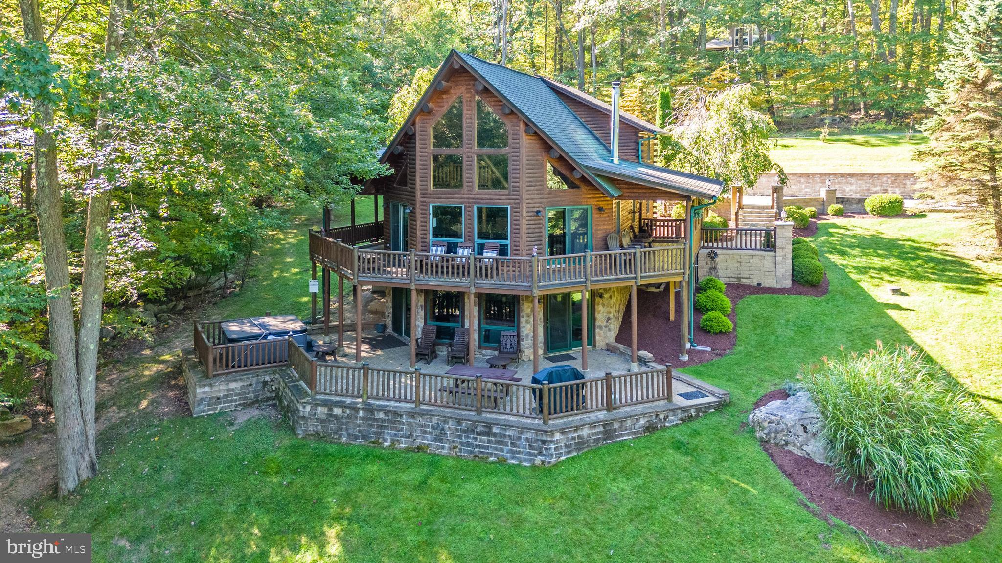 If it's privacy and convenience you want, you will love this beautiful log home on a 1.6-acre site with seasonal lake views and a path that leads to restaurants and the lake! Enjoy an open floor plan, cathedral ceilings, two fireplaces, large family/game room, hot tub, block paver landscaping and lots of space to entertain. The home also boasts many recent upgrades which include new lower-level gas fireplace, new lower-level flooring, new carpet, new deck boards and marble countertops. The Mountainside Community amenities include a lakefront clubhouse, lake access and a pavilion. The location is also just minutes to Wisp Ski Resort, call today to preview.