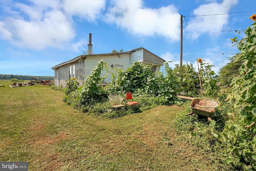 Beautiful country living on 7-Acres on RT 621 Minutes from Rt 20. It can be divided into two parcels. Well and septic on site. Mobile home AS-IS  3br/1 ba, kitchen, living room, deck. Property is sold in As-Is condition only. A metal roof is only a few years old.  Kitchen with a fridge, sink, and stove. Plat available.