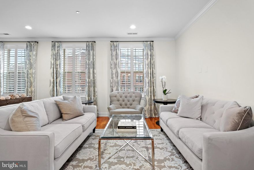 Introducing a magnificent townhome that encapsulates luxury living in the heart of Philadelphia!  Ideally located in a prized, gated enclave just south of Fitler Square, and only steps to University City, this Naval Square home is exactly what you have been waiting for! 708 Captains Way is an exquisite bi-level townhome boasting 4 bedrooms, 2 full baths, 2 half baths and a deeded parking space! As you step inside this pristine home, you'll immediately notice the care and dedication the owners have put into both updating and maintaining this lovely home. The location of 708 is prime— uniquely positioned and nonadjacent to other townhome buildings — this home offers unmatched privacy and seclusion, in addition to affording it an abundance of natural light! On the first level, you will be welcomed into a spacious open concept living/dining area with gorgeous cherry hardwood flooring, freshly painted walls and upgraded recessed lighting. Next, flow seamlessly into the well designed kitchen with professionally refinished white shaker-style cabinets, stainless appliance suite, including an LG Counter depth French door refrigerator. Tumbled marble tiled backsplash & sleek granite counters and large pantry complete the space. An adjacent, more casual eat-in-kitchen area is the perfect space to enjoy your morning coffee. The adjoining family room is full of sunshine, and opens to a private terrace spanning the full length of the property. The spacious terrace embraces beautiful treetop views and a stunning vantage of the nearby Roberts Center. On the second level, you will find an elegant primary suite with vaulted ceilings, upgraded hardwood flooring, and a luxurious walk-in-closet, completely outfitted with gorgeous custom built-ins by Closets by Design. Luxe ensuite bath features upgraded dual sinks, granite tops, soaking tub & separate shower with frameless glass enclosure. On this level, you will also find two additional sunlit bedrooms, full bath, and laundry closet with built-in cabinets and a newer side-by-side LG washer & dryer (2024).  Just when you think you have seen it all- there is an entire additional level! The recently finished basement boasts a 4th bedroom with a large window, PLUS a nice sized den/ study and a beautiful 2nd half bath. Tucked away under the stairs you will find TWO spacious storage closets with practical storage solutions.  Enjoy neutral paint, newly carpeted stairs to the basement, upgraded light fixtures & bathroom hardware, and beautiful plantation shutters throughout the entire home.  Have peace of mind knowing that the hot water heater was replaced in 2021 and there are two HVAC units (lower unit is original and upper unit was replaced in 2022). Smart home features include: one Nest thermostat. Deeded pull-in parking space (700 Captains Way Unit #P359) is just steps from the home. 
Enjoy the ease of having the pool & state-of-the-art fitness center less than a minute walk from your building and the concierge close by. The dramatic community room in Biddle Hall rotunda is perfect to reserve for private parties. Enjoy the outdoor amenities of the 20-acre park-like setting: including picnic areas, well-kept gardens & mature landscaping. With a gated entry and on-site visitor parking, convenience and security are paramount. Very close proximity to South Street Bridge, UPenn (0.7 mi), CHOP, HUP & Drexel, Rittenhouse (0.9 mi) & Fitler Square. Fantastic restaurants and cafes, such as Rival Bros Coffee, Friday Saturday Sunday (James Beard Winner), Illata BYOB, Pub & Kitchen, Southgate, Sabrina's & Loco Pez, are all just steps outside the gates. The new Heirloom Market by Giant and South Square Market are only a block away. Directly out the back gate you will find easy access to the Schuylkill River Park, including the Award Winning Trail & Boardwalk, Markward playground, Tennis Courts & dog park!