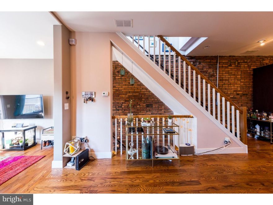 Phenomenal three year old bi-level condo with tax-abatement thru 2024. Exposed ducts, brick walls, 9' & 10' ceilings (main floor), and beautiful oak hardwood floors throughout. Ideal location in the heart of Bella Vista; close to parks, shops, entertainment, dining, the Italian Market, and much more with a 96 WalkScore. Bright open main floor with three exposures (southern, western, & eastern), living room, dining (plenty of space for formal/large dining table), kitchen, and private deck perfect for entertaining and family gatherings. Amazing kitchen with custom soft-close cabinetry & built in pantry, stainless steel GE appliance package and a 7' breakfast bar overlooking the dining, living, and private deck. Also on the main level; full bath with stand-up shower, tri-shower-head system, penny-tile shower flooring, subway-tile surround, and a spacious second bedroom with ample closet space.  The second floor of the unit opens up to flex-space, currently being used as a den (also perfect for an office). Stacked washer and dryer in hall closet.  The top floor also includes a full bath, master bedroom with three closets, and a second private deck just off the master bedroom. Center City Philadelphia skyline views from both decks and the top floor flex-space.  Great location, spectacular unit with plenty of storage, and extremely low condo fees.