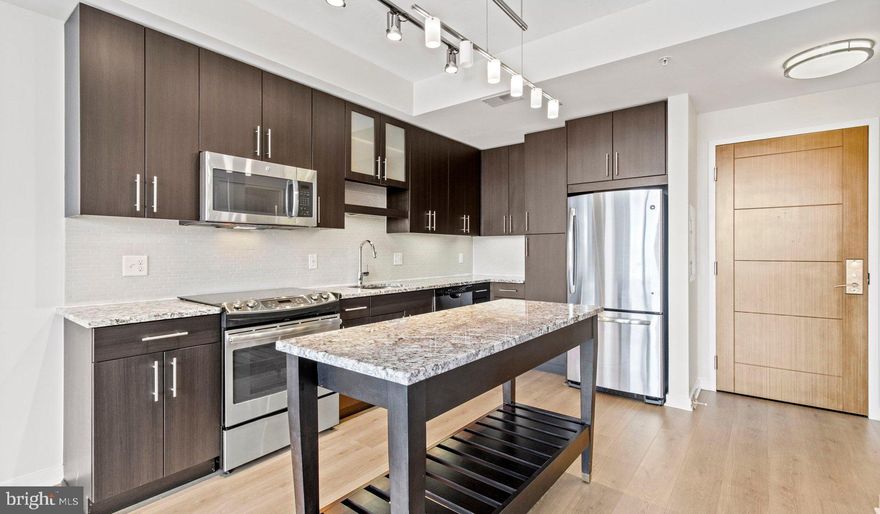 Nestled in the vibrant heart of Bethesda, Maryland, this luxury apartment complex offers an unparalleled living experience that combines modern convenience with sophisticated design. Designed to cater to the discerning tastes of urban dwellers, this property stands as a testament to luxury living, where every detail has been meticulously crafted to ensure the utmost in comfort and style.

*Exceptional Location*
Located in the sought-after Woodmont district, the apartment complex is perfectly positioned as a gateway to the best that Bethesda has to offer. Residents enjoy easy access to a plethora of amenities, including the Walter Reed National Military Medical Center, the NIH, and a variety of shopping, dining, and entertainment options. The prime location also offers convenient access to public transportation, making it easy to explore the wider metropolitan area.

*Architectural Elegance and Design*
The building's U-shaped design opens up to a beautifully landscaped courtyard, offering a seamless transition from the bustling city life to a tranquil oasis. The architecture is both richly textured and humanly scaled, creating an inviting streetscape that residents are proud to call home. A dramatic window wall façade and ground-level duplex units with front porches and planters further enhance the building's aesthetic appeal.

*Luxurious Amenities*
Residents of this apartment complex enjoy access to an array of exceptional amenities designed to enhance their lifestyle. The property boasts a large fitness center, fireside lounges, and a rooftop lounge equipped with bars, fireplaces, grilling areas, and two pools. Additionally, the convenience of having a 50,000 square foot grocery store within the building cannot be overstated. The property is also LEED Gold Certified, reflecting a commitment to environmental sustainability.

*Sophisticated Living Spaces*
The apartments themselves are a reflection of the luxury and sophistication that define the property. With a variety of floor plans, including studios, one to three-bedroom apartments, and townhomes, there is something to suit every preference. Each unit features designer finishes, stainless steel appliances, and spacious layouts that make coming home a pleasure.

*Community and Convenience*
The property is known for its friendly and helpful staff, ensuring that the needs of residents are met with professionalism and care. The well-maintained common areas and the sense of community fostered among residents make this complex more than just a place to live—it's a place to belong.

This luxury apartment complex in Bethesda, Maryland, offers an unmatched living experience for those seeking the best in urban living. With its prime location, architectural elegance, luxurious amenities, and sophisticated living spaces, it stands as a beacon of modern luxury and convenience. Realtors and renters looking for a property that combines the vibrancy of city life with the comfort of upscale living will find everything they desire and more at this premier apartment complex.

** Pricing and availability subject to change on a daily basis ** Photos are of model units ** Parking may be available for additional fee **